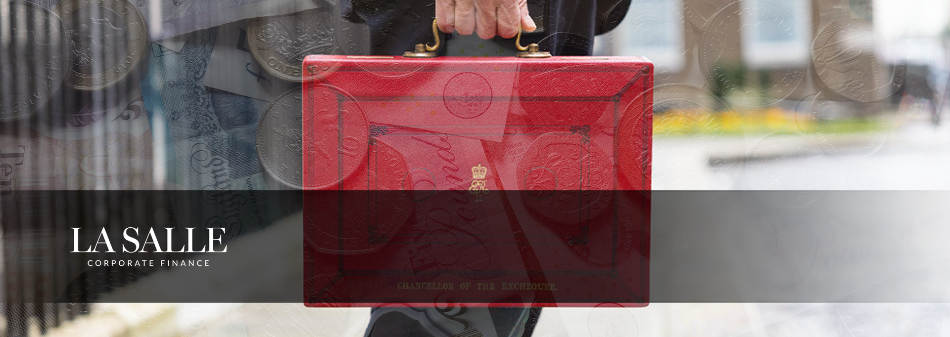 Hand holding a red shopping bag with a transparent center on a city street