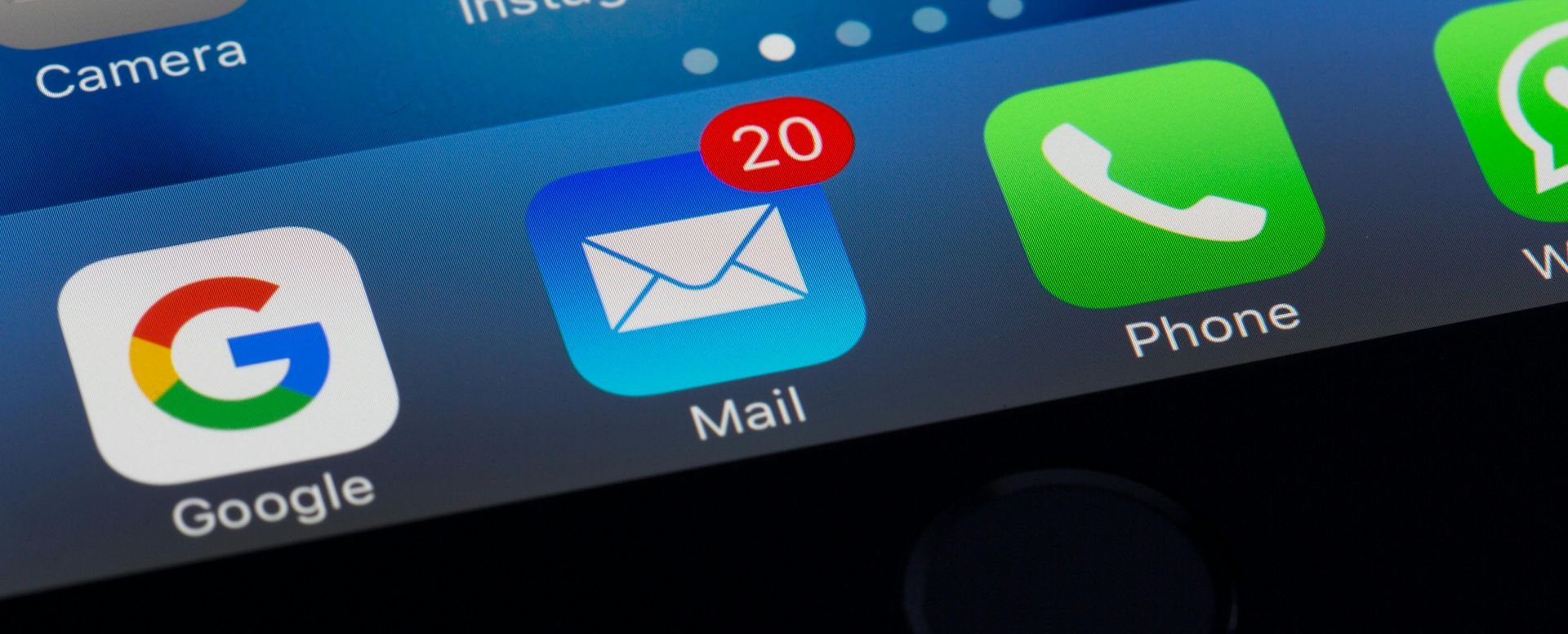 Close-up of a smartphone home screen with Google, Mail, and Phone app icons, Mail showing 20 unread messages