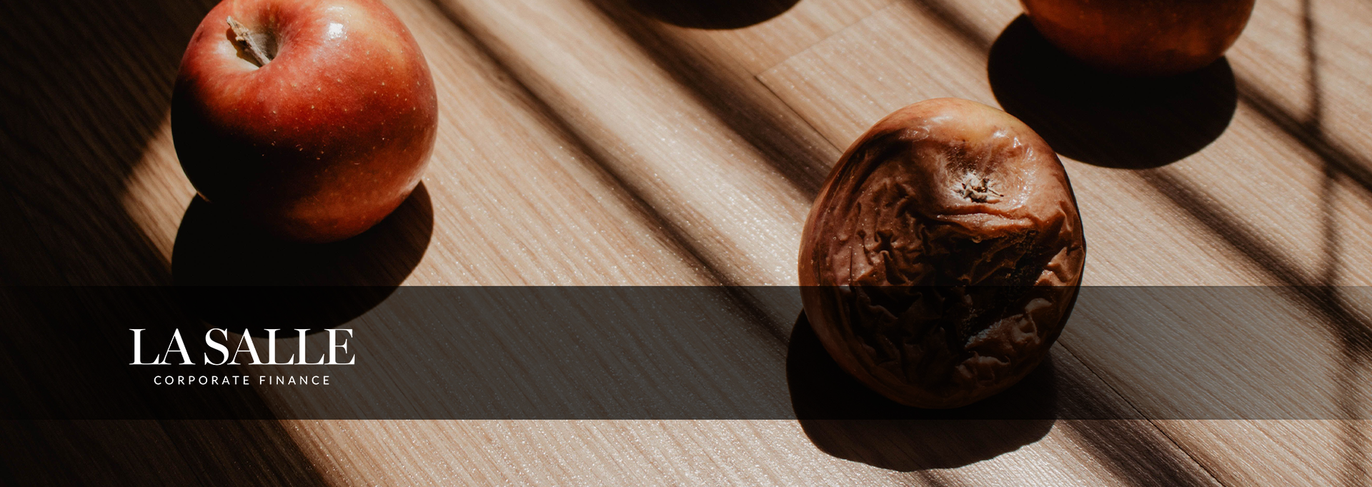 Colorful shipping containers stacked in rows, forming an aerial view of a cargo yard with a striped roadway.
