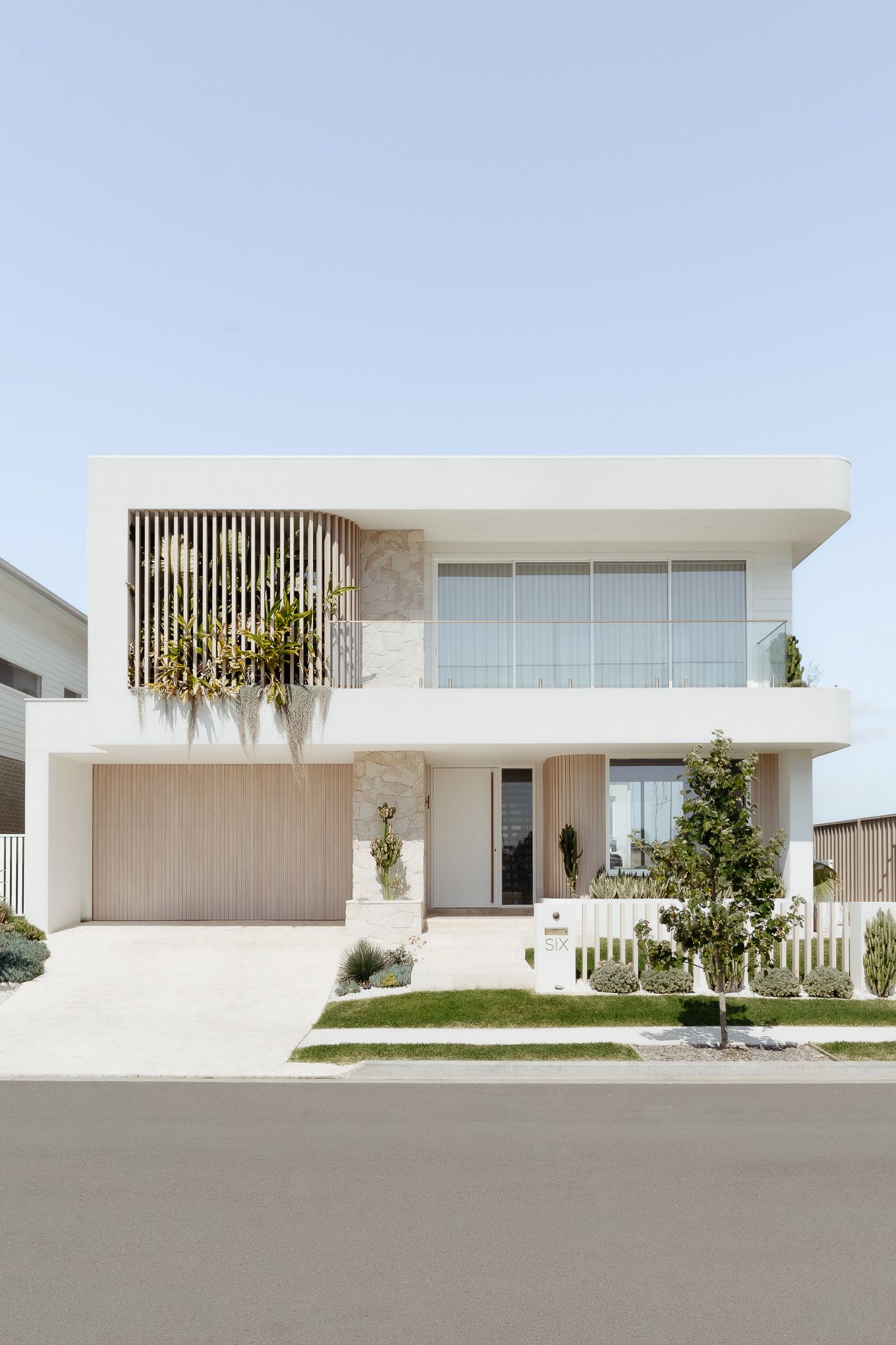 Modern Two-story White House With a Wooden Garage Door and Balcony — SDC Building Design In Kiama, NSW