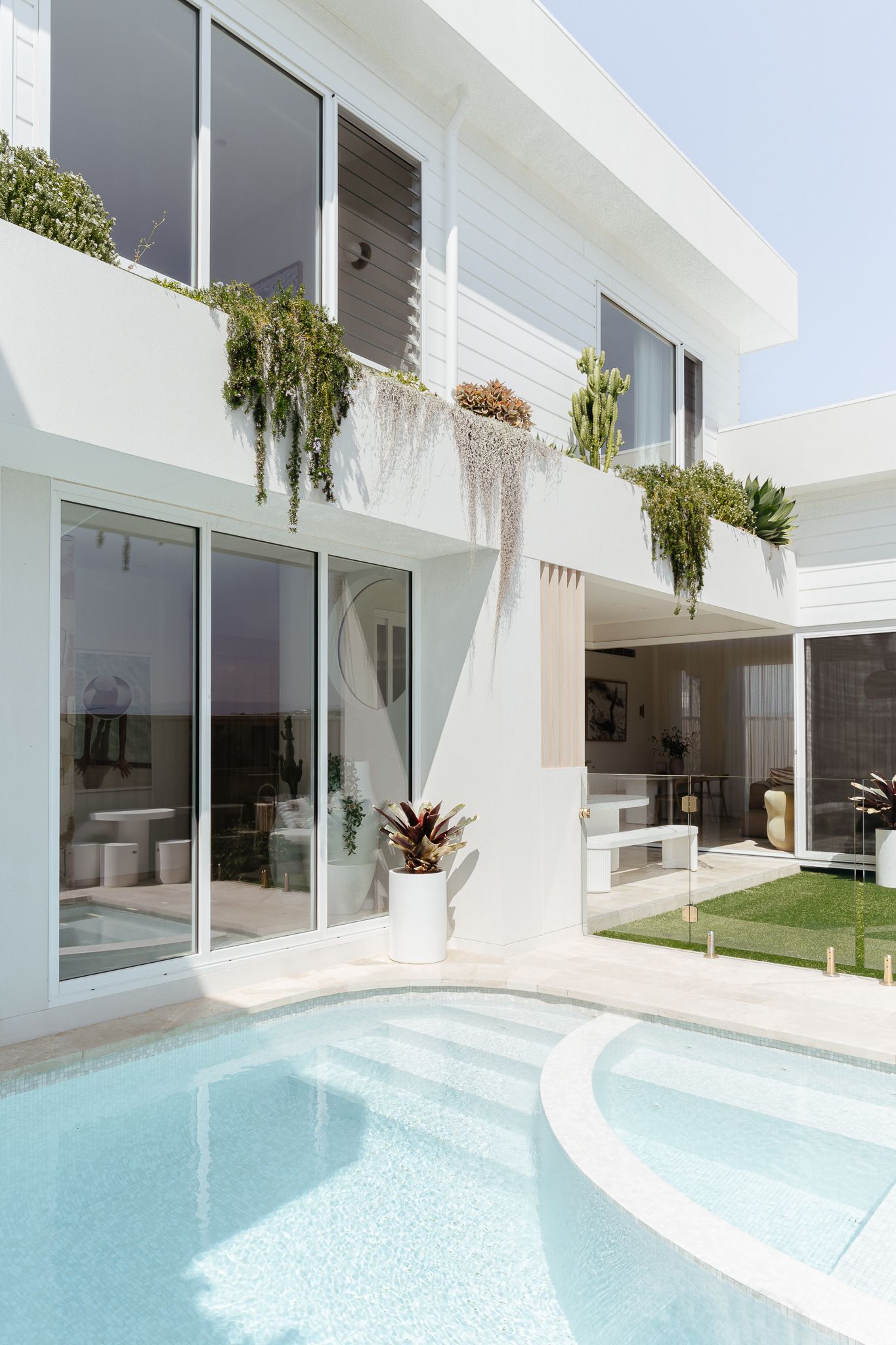 White house with pool; hanging plants, glass doors — SDC Building Design In Wollongong, NSW