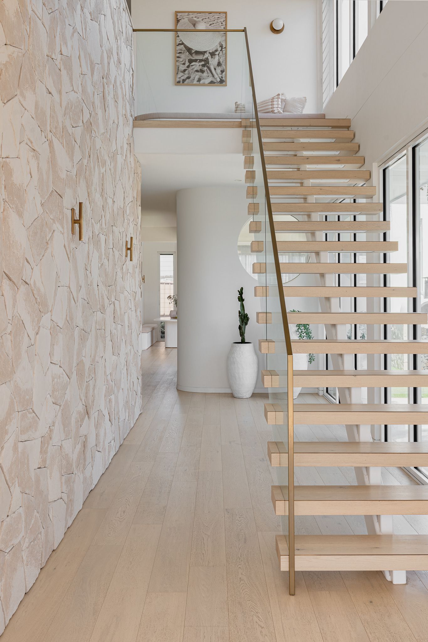 Hallway with textured white wall, wooden staircase, and a light-filled interior — SDC Building Design In Wollongong, NSW