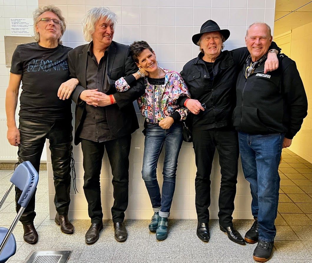 A group of people standing next to each other in a room.