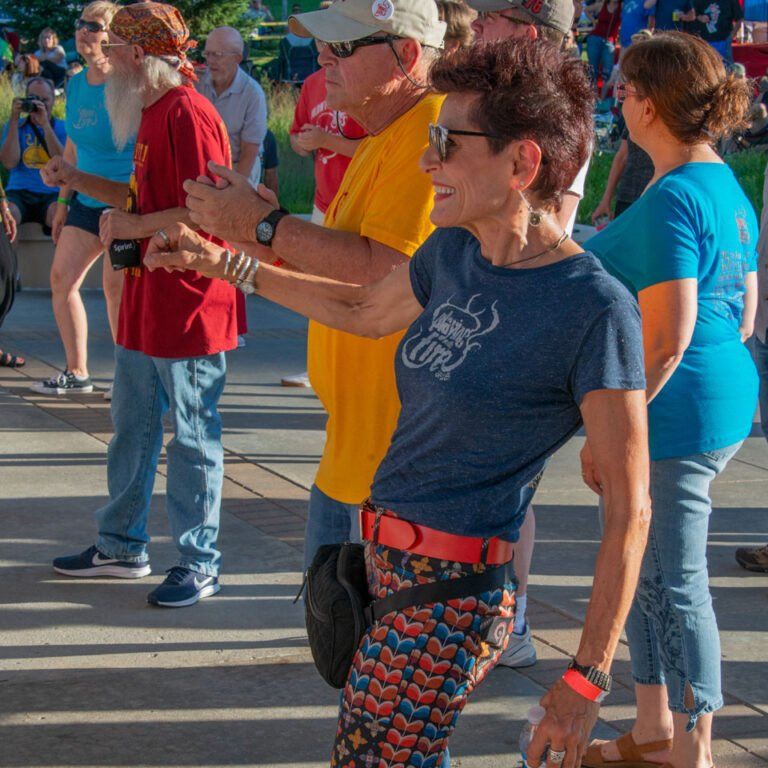 A woman wearing a blue shirt with the word ford on it