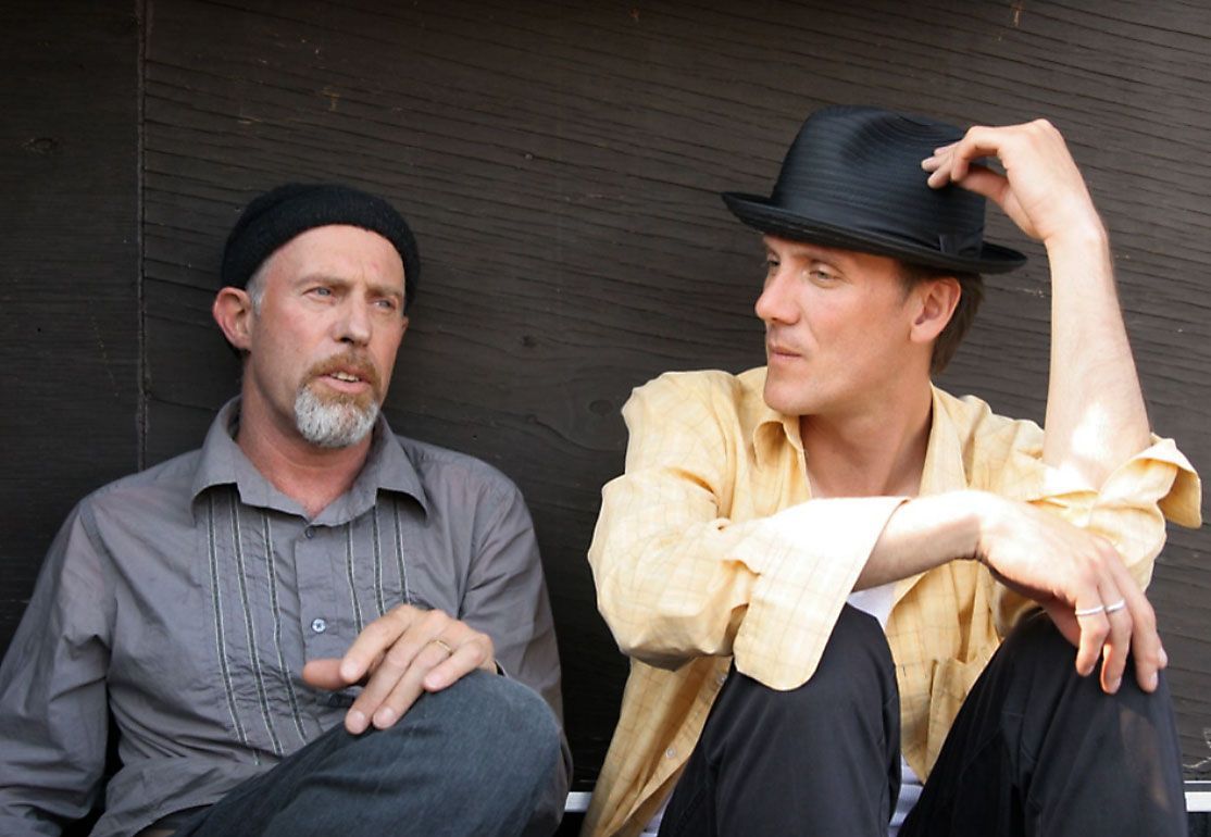 Two men sitting seemingly having a quiet conversation.