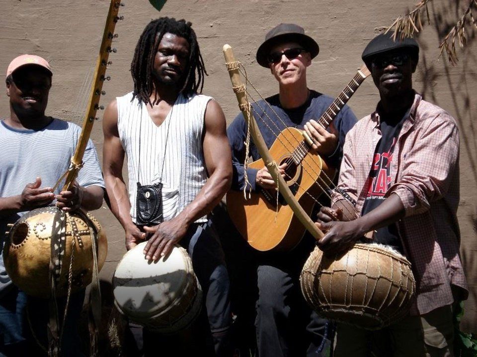 A group of men standing next to each other holding musical instruments