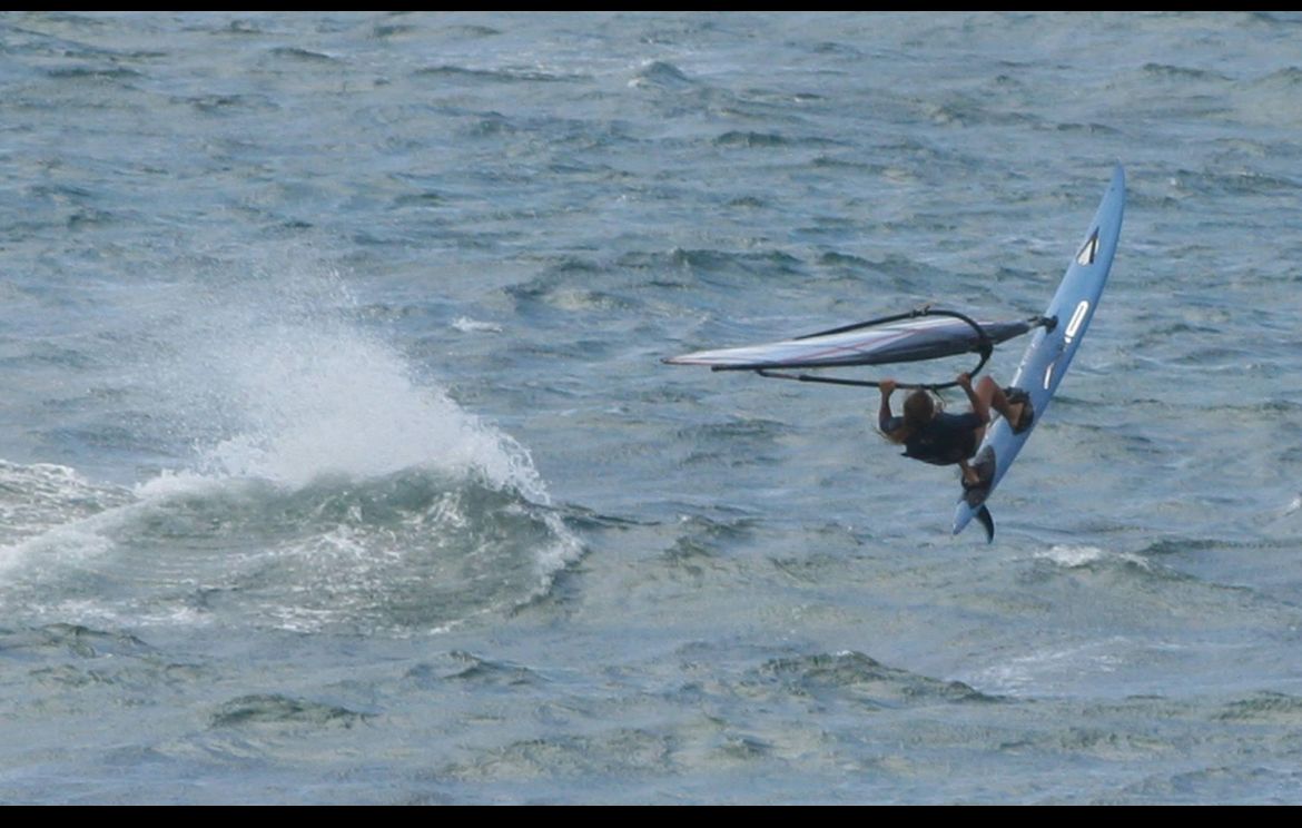 A person is riding a wave on a surfboard in the ocean