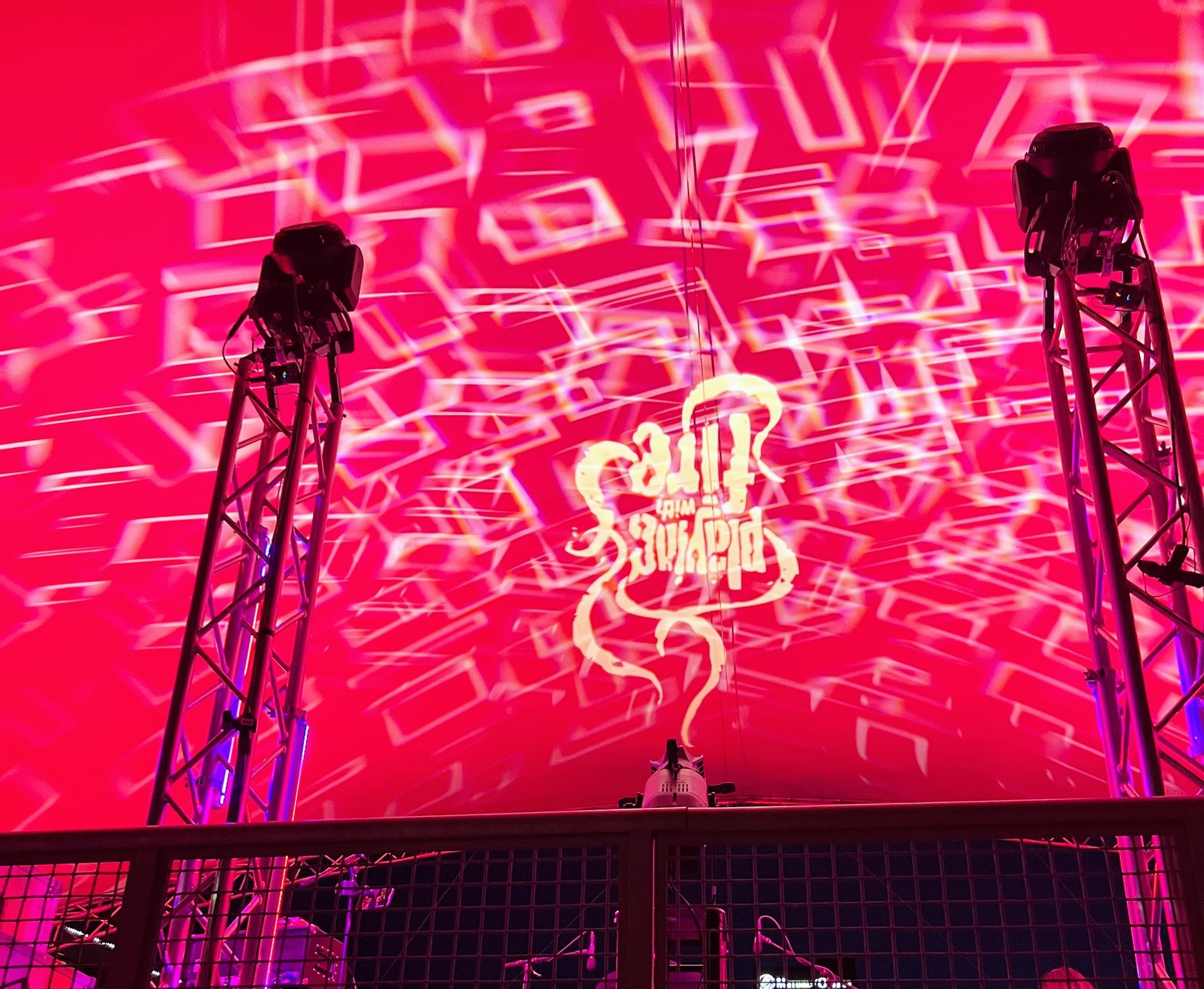 A stage with a red background and a dj on it