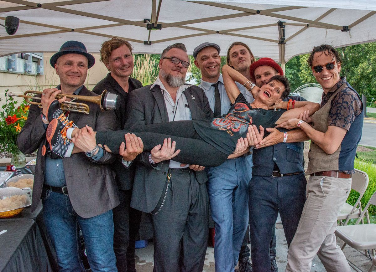 A group of people are posing for a picture under a tent.