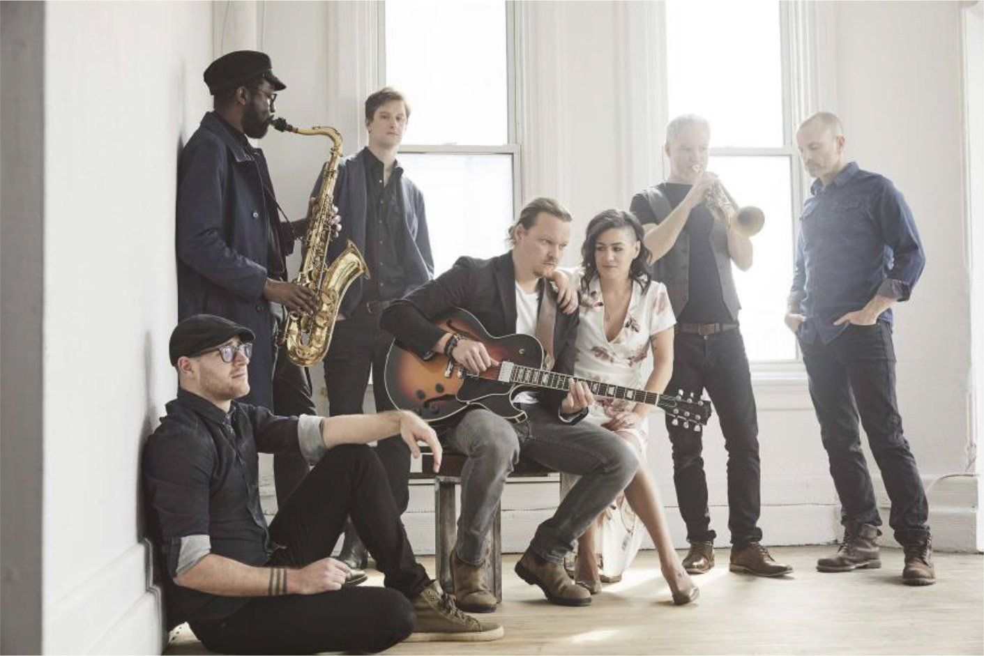 A group of people are playing instruments in a room.