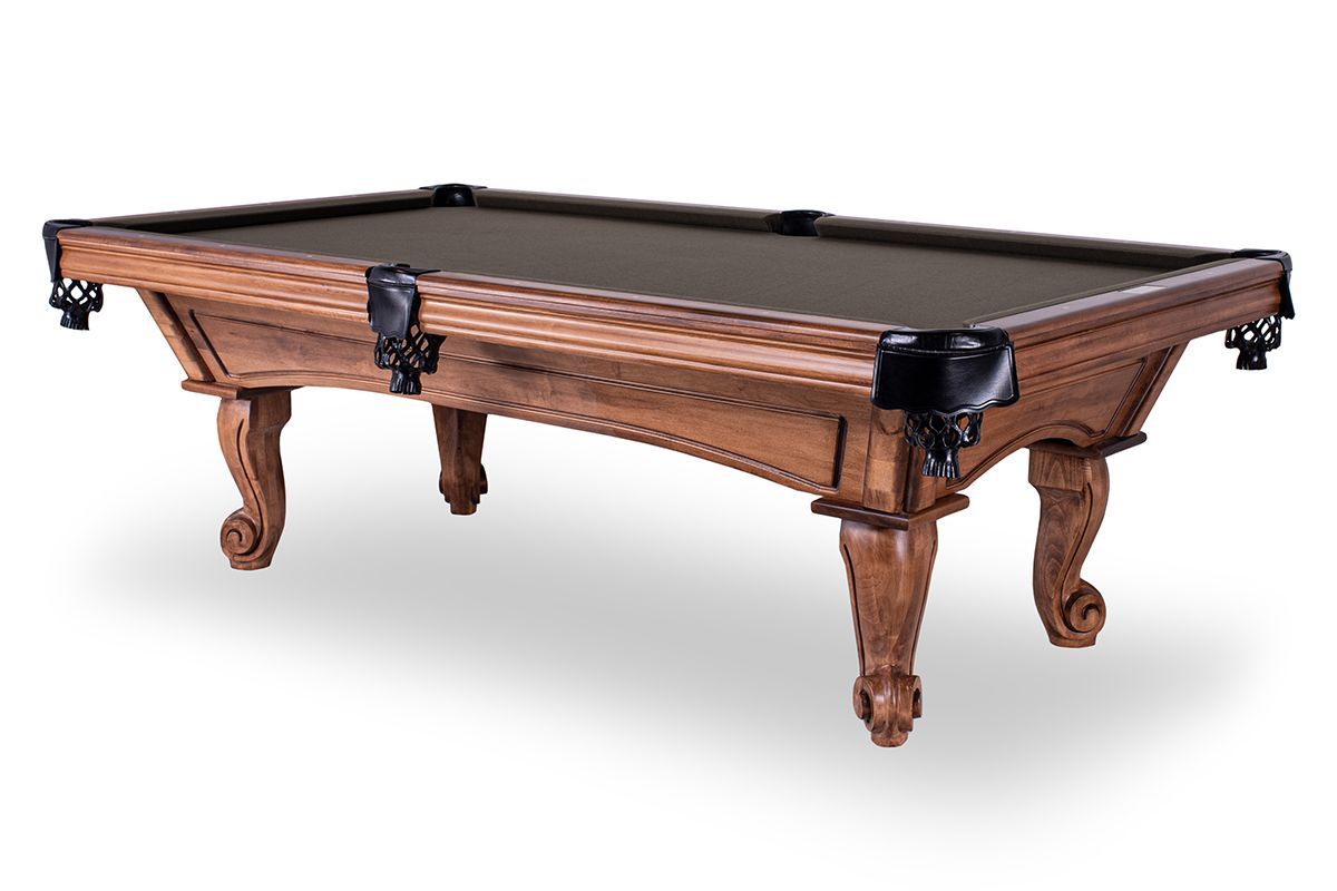 Wooden pool table with green felt and ornate carved legs on a white background