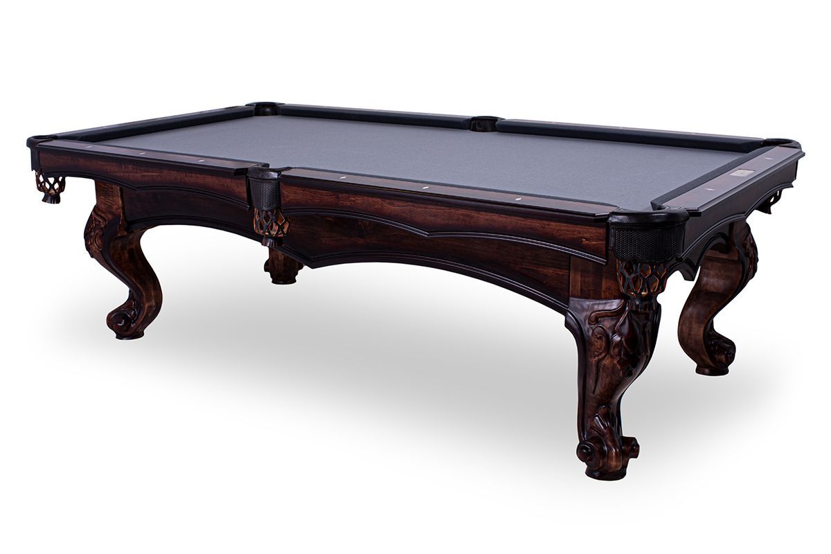 Ornate dark wood billiard table with green felt on a white background