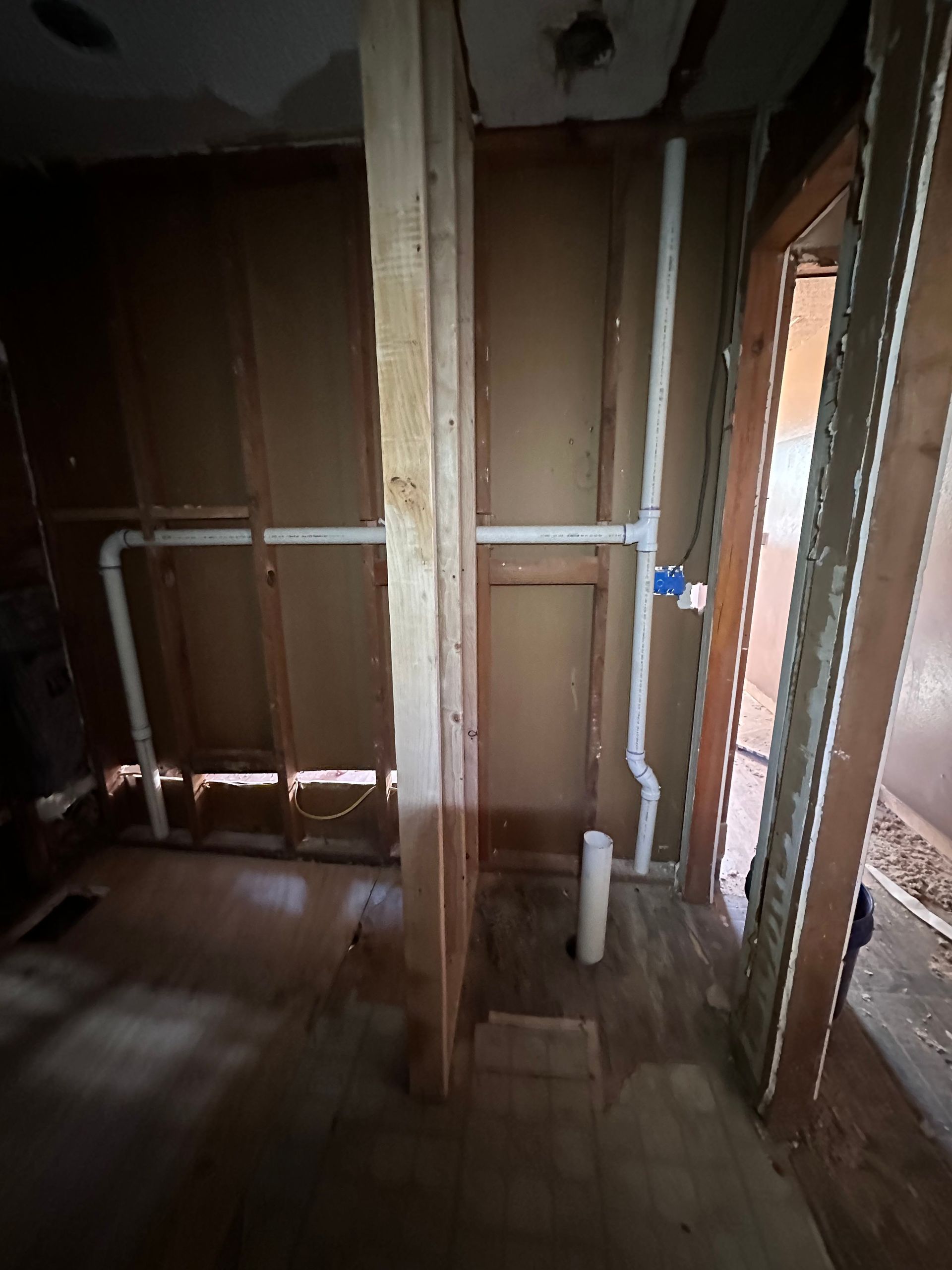 A room with wooden walls and pipes in it