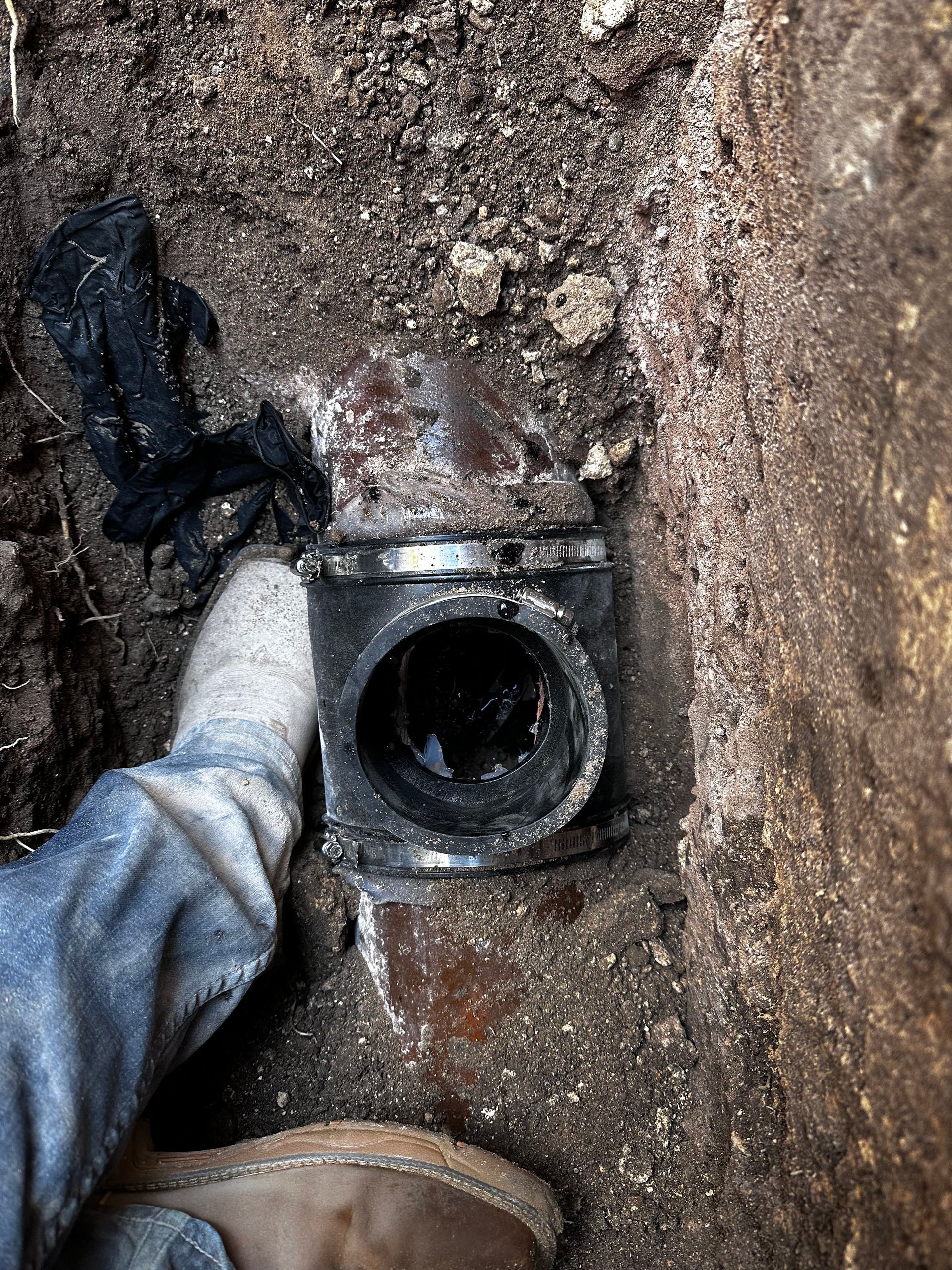 A person standing next to a hole in the ground