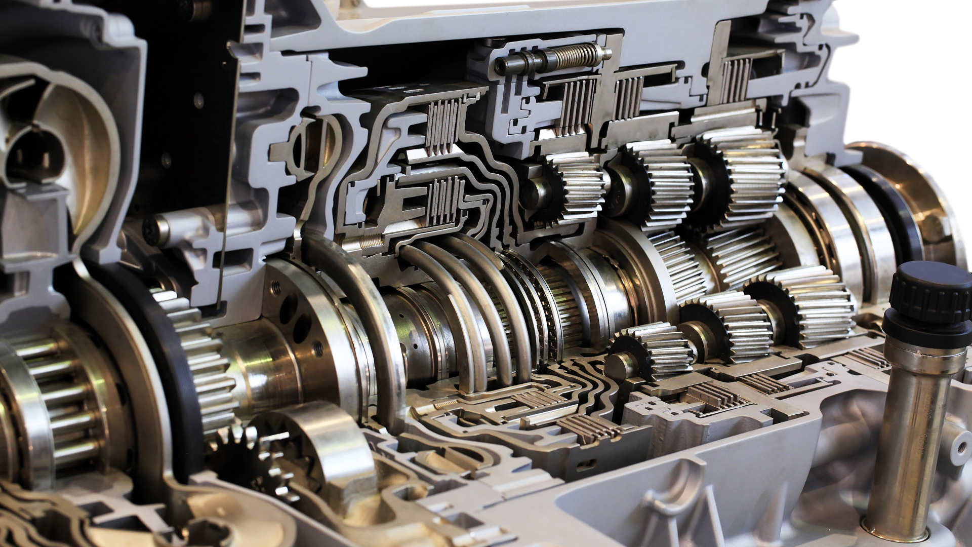 A close up of the inside of a gearbox on a white background
