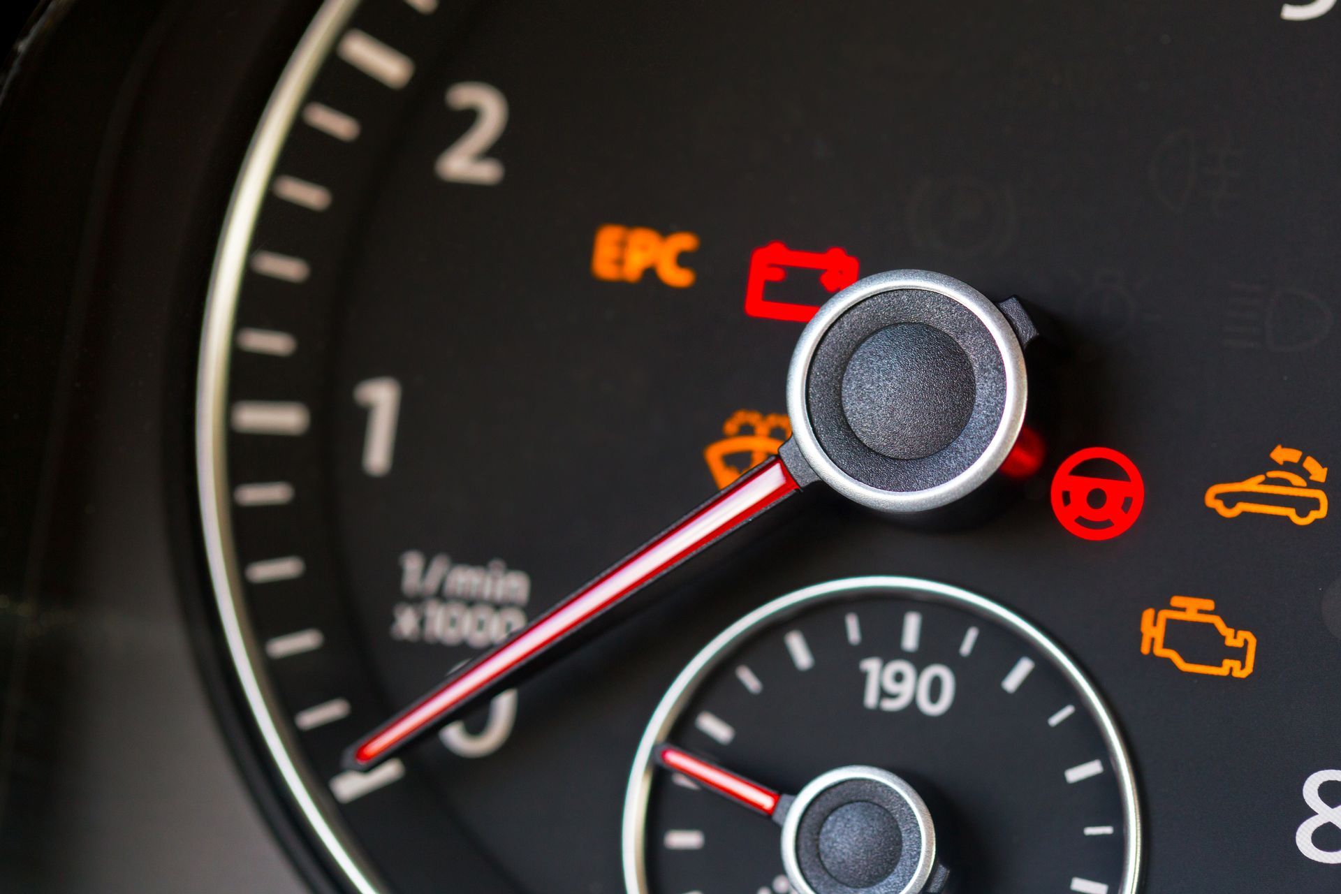 Car dashboard speedometer with several warning lights illuminated, including EPC and engine icons