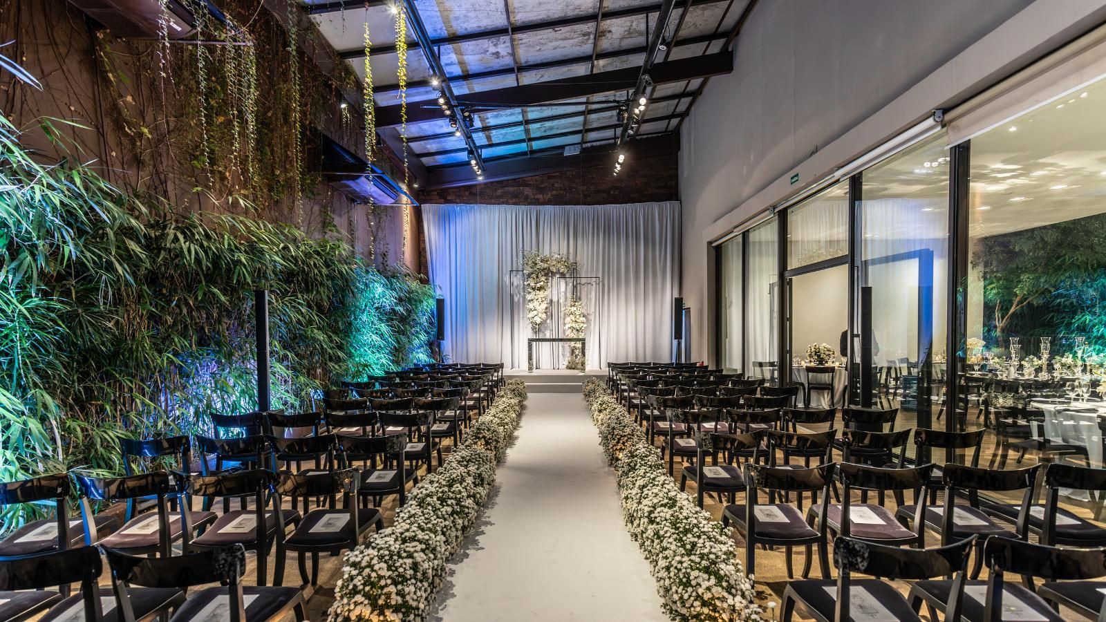 beautiful historic wedding venues A large room with rows of chairs and flowers on the aisle.