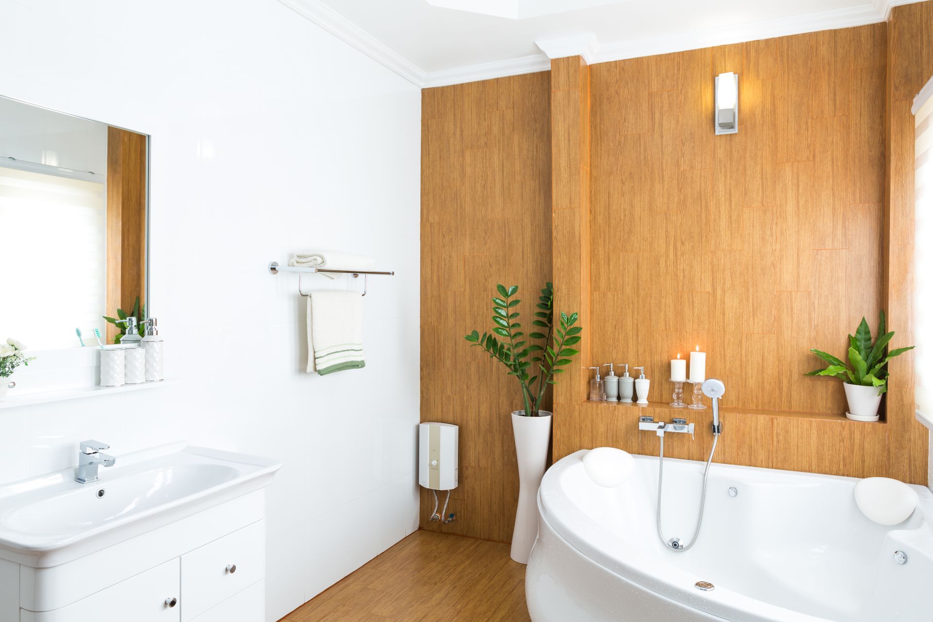 Bathroom with white sink, tub, and walls; brown wood paneling.
