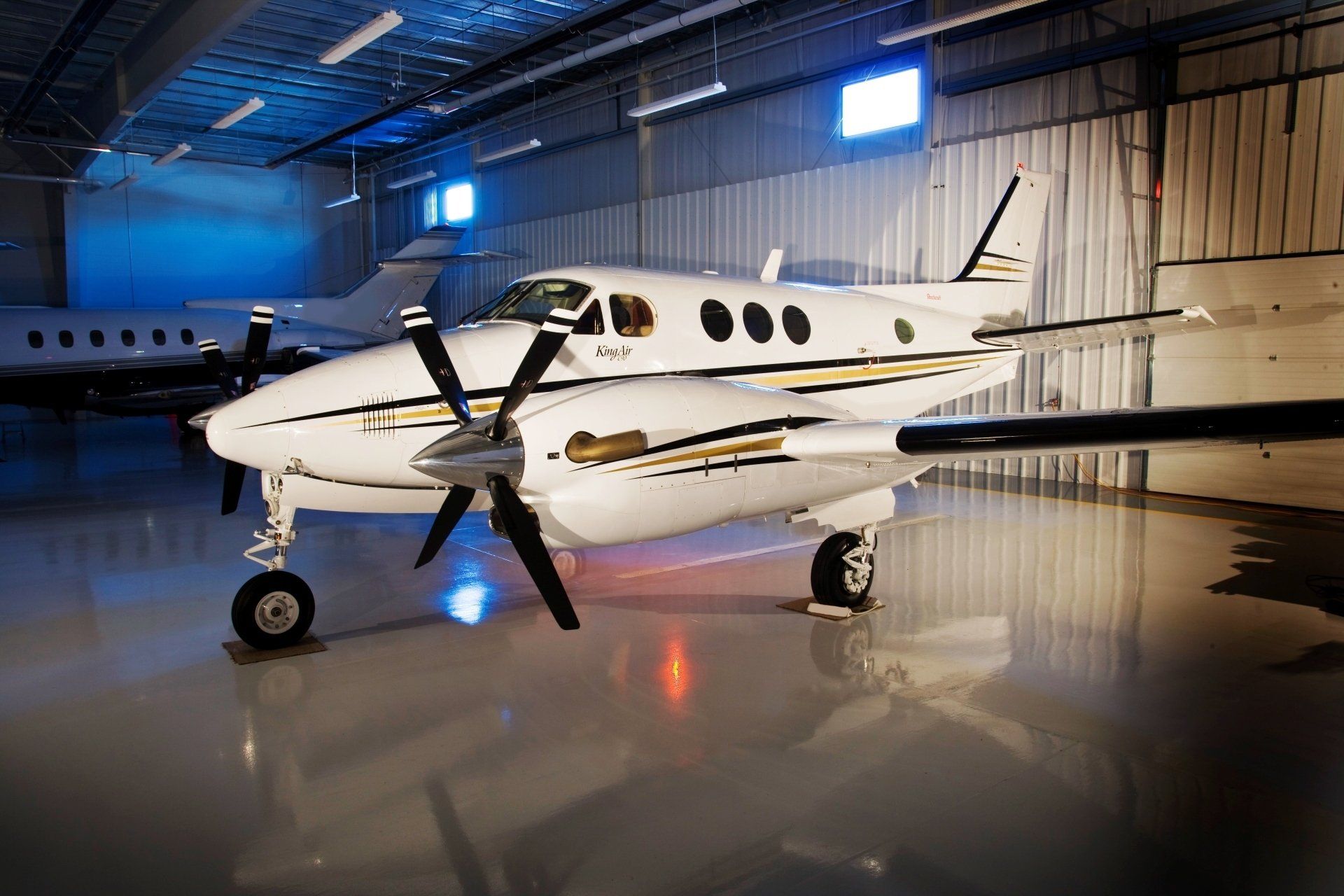 A small propeller plane is parked in a hangar