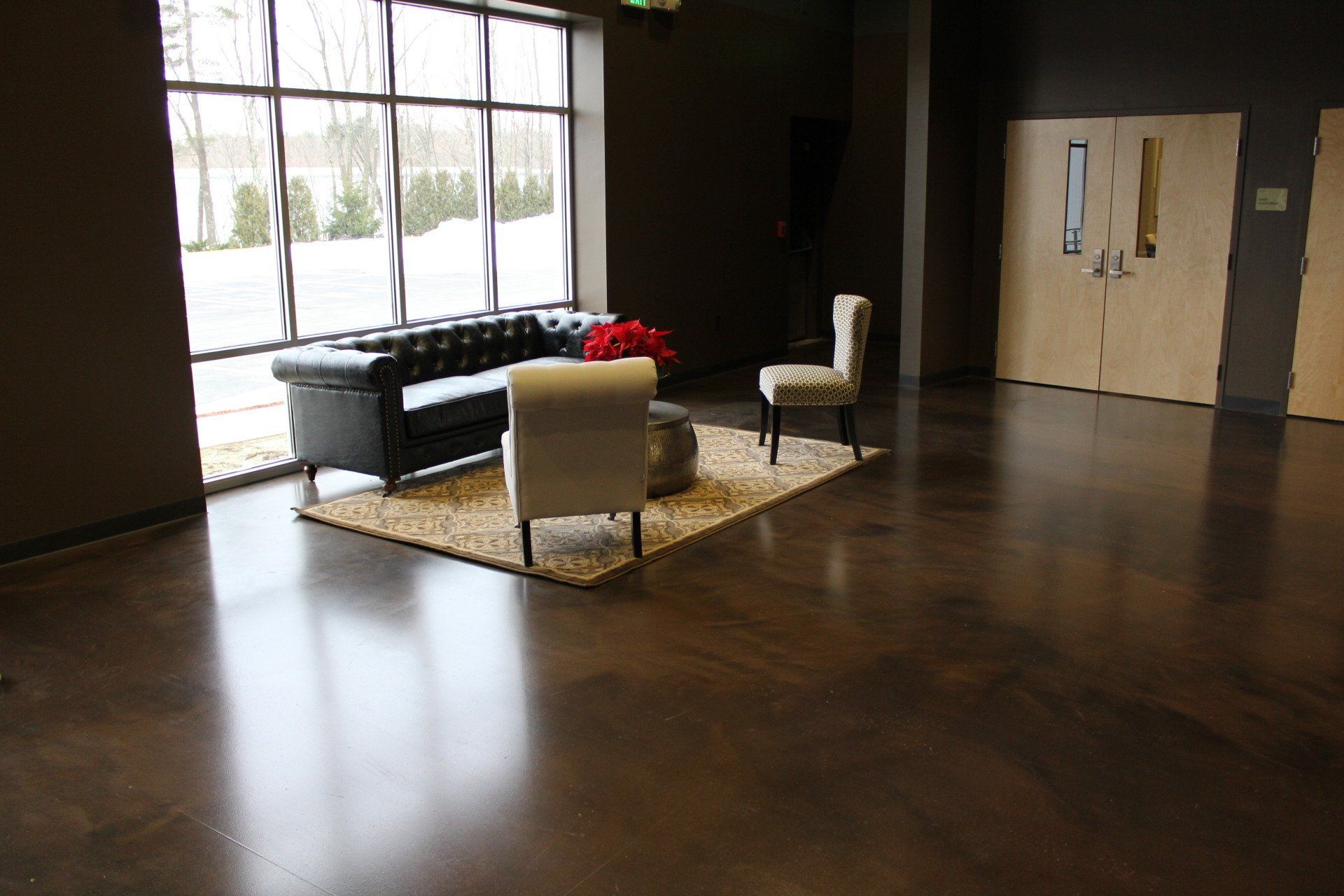 A living room with a couch , chairs and a table