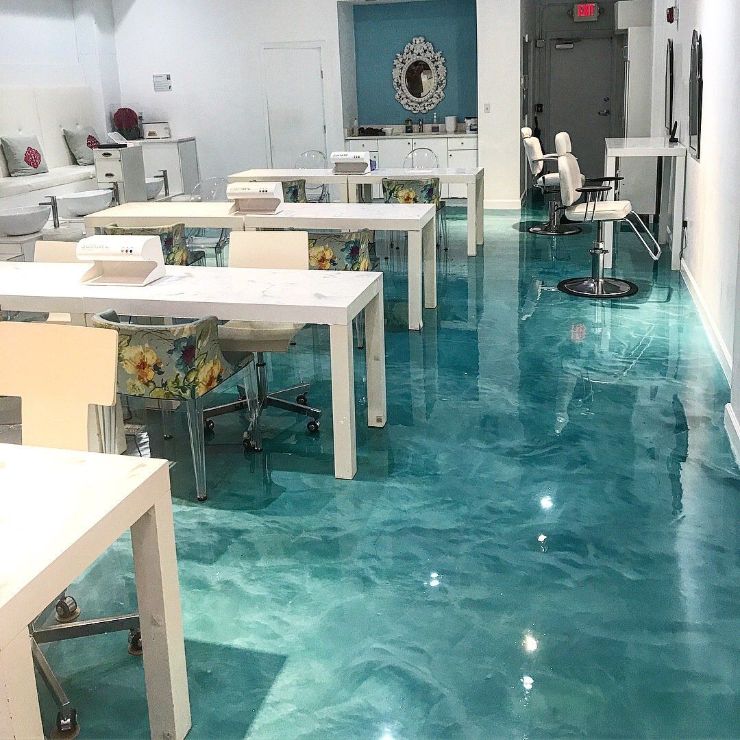 A room with tables and chairs and a blue floor