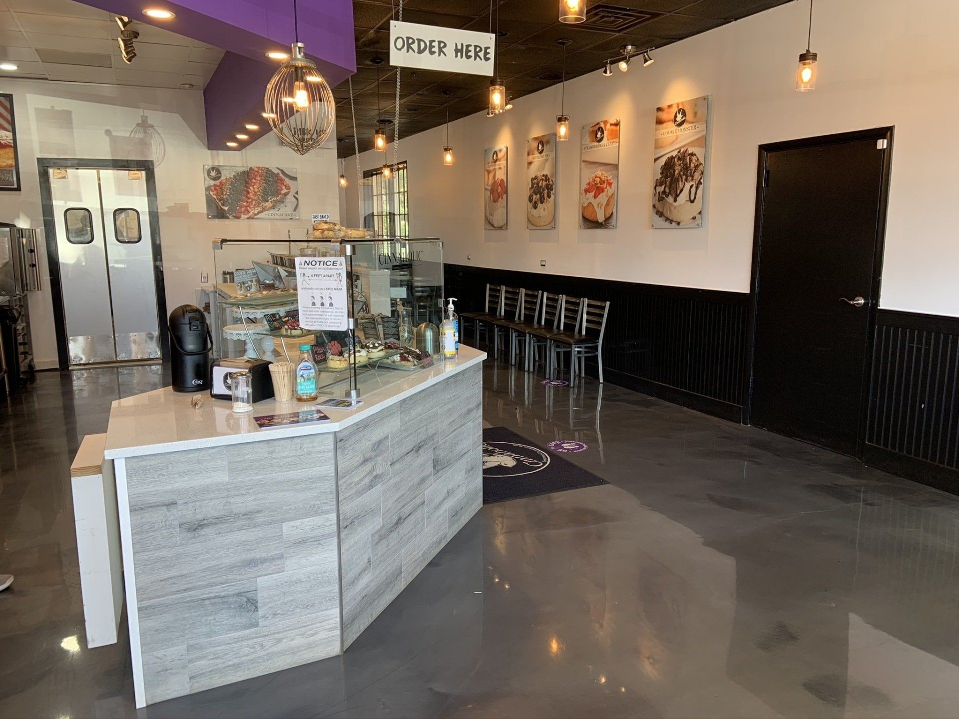 A restaurant with a counter in the middle of the room.
