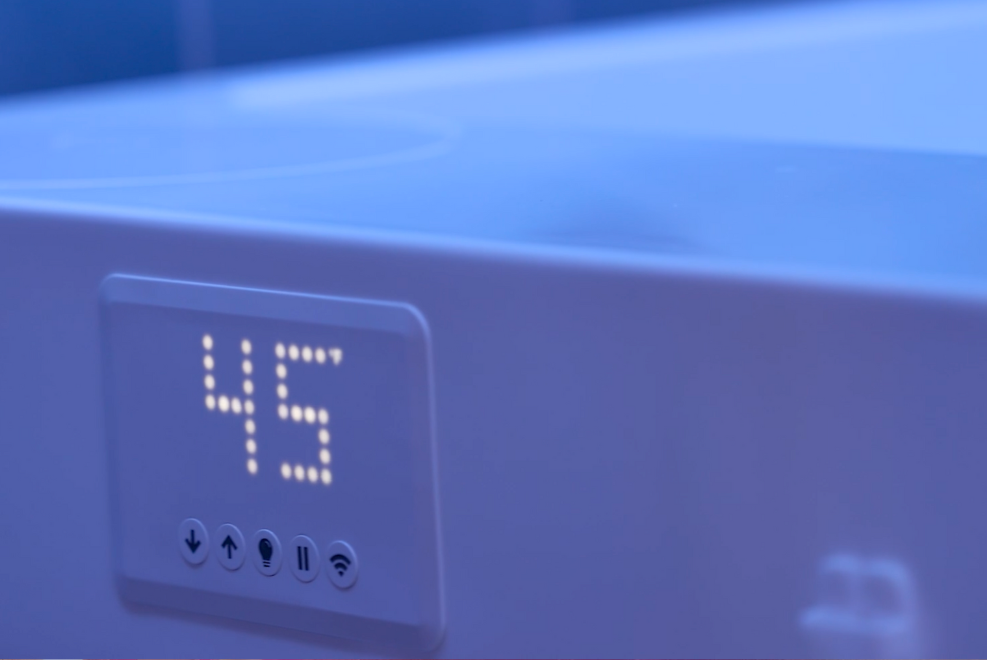 Blue appliance control panel showing a digital “45” display with small buttons below.