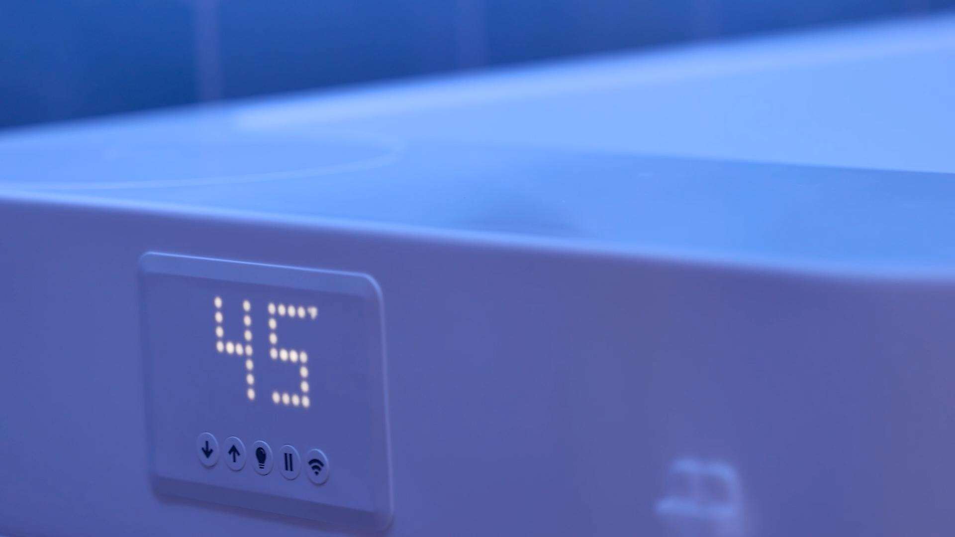 Blue electronic display showing “45” on a device panel with indicator lights