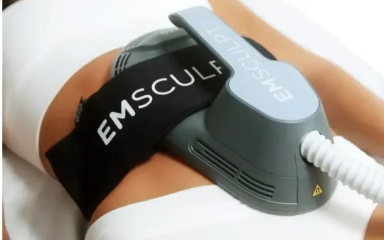 EMSculpt body-contouring device strapped to a person’s abdomen, with a connected cable.