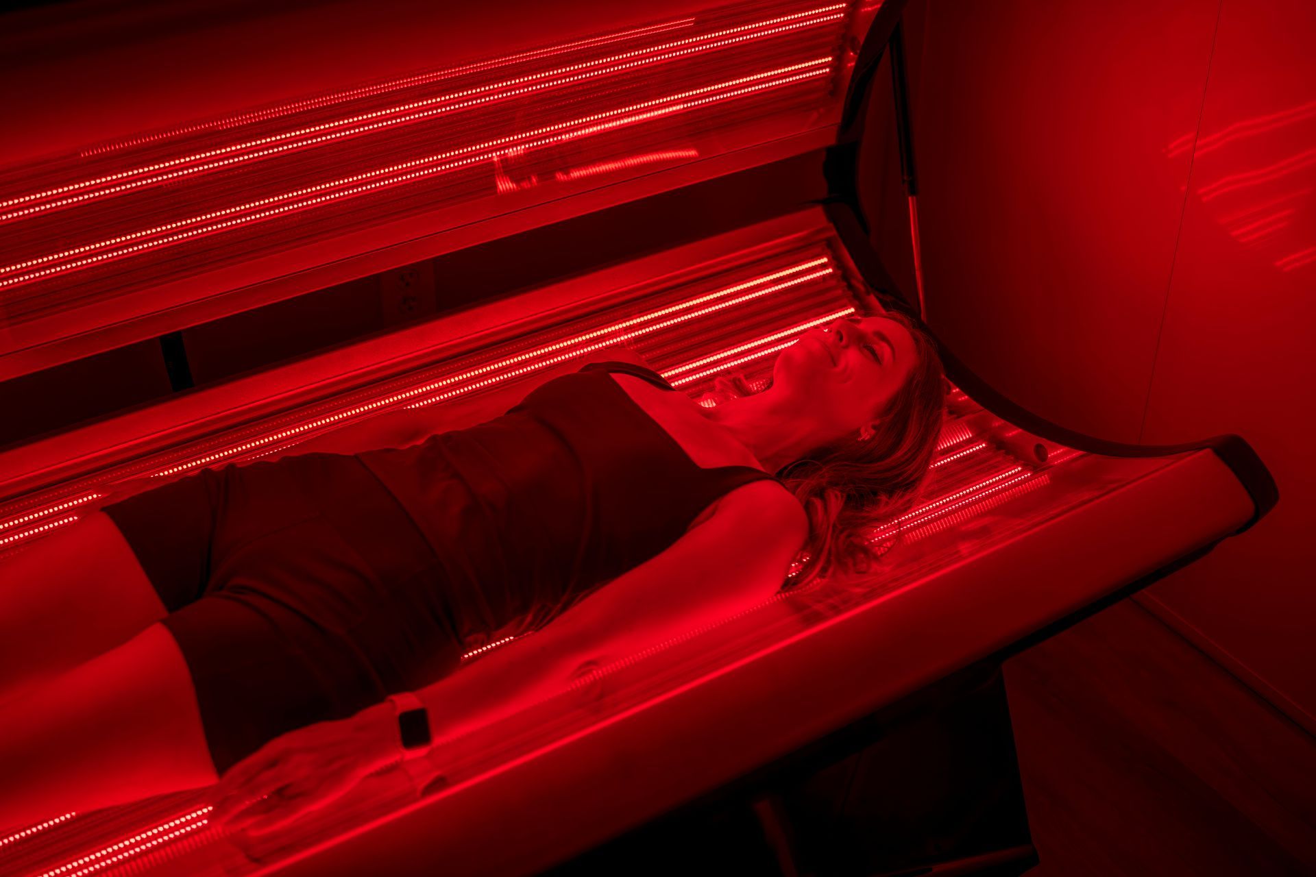 Red-lit car interior with illuminated dashboard and door panels.