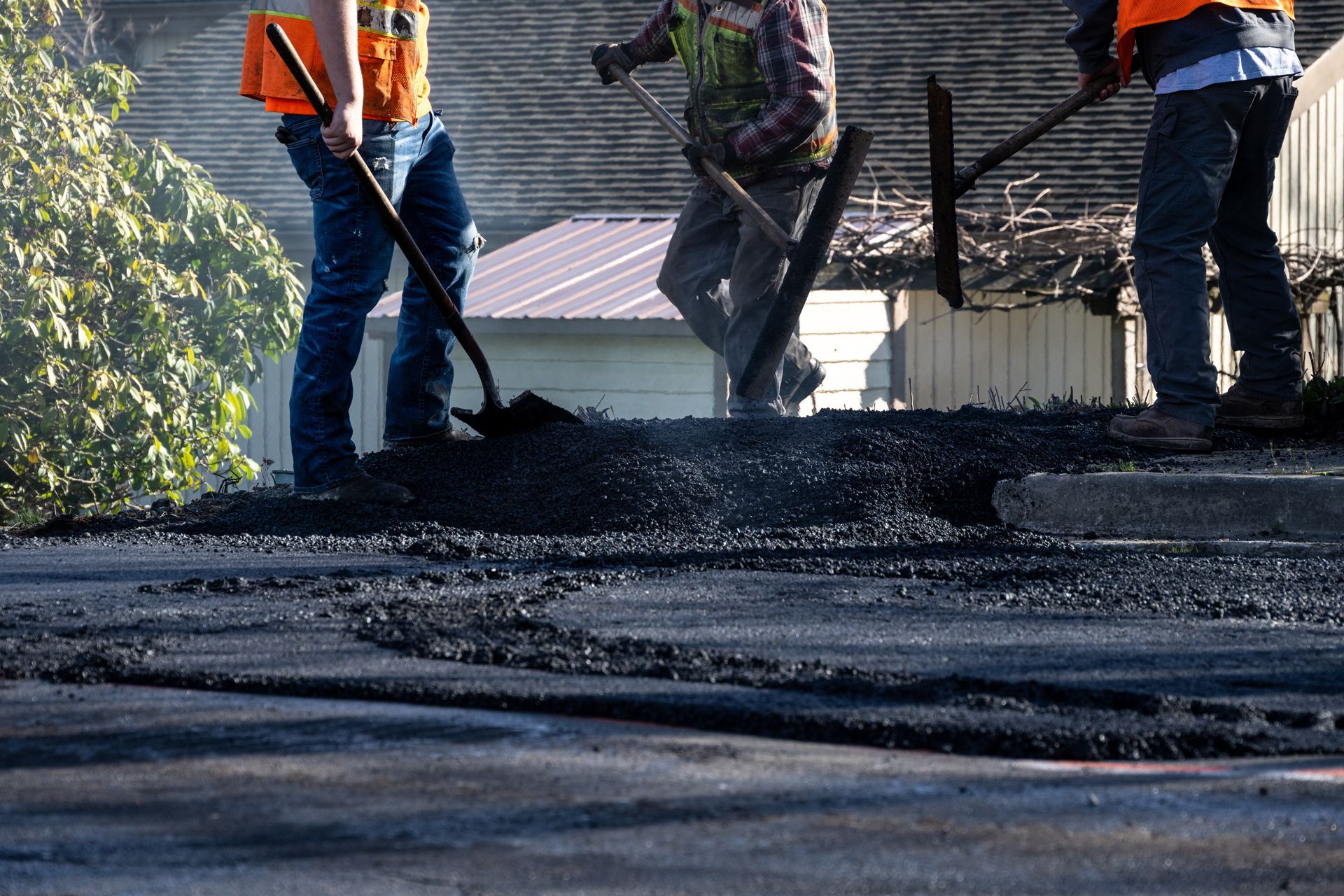 A group of construction workers are working on a road