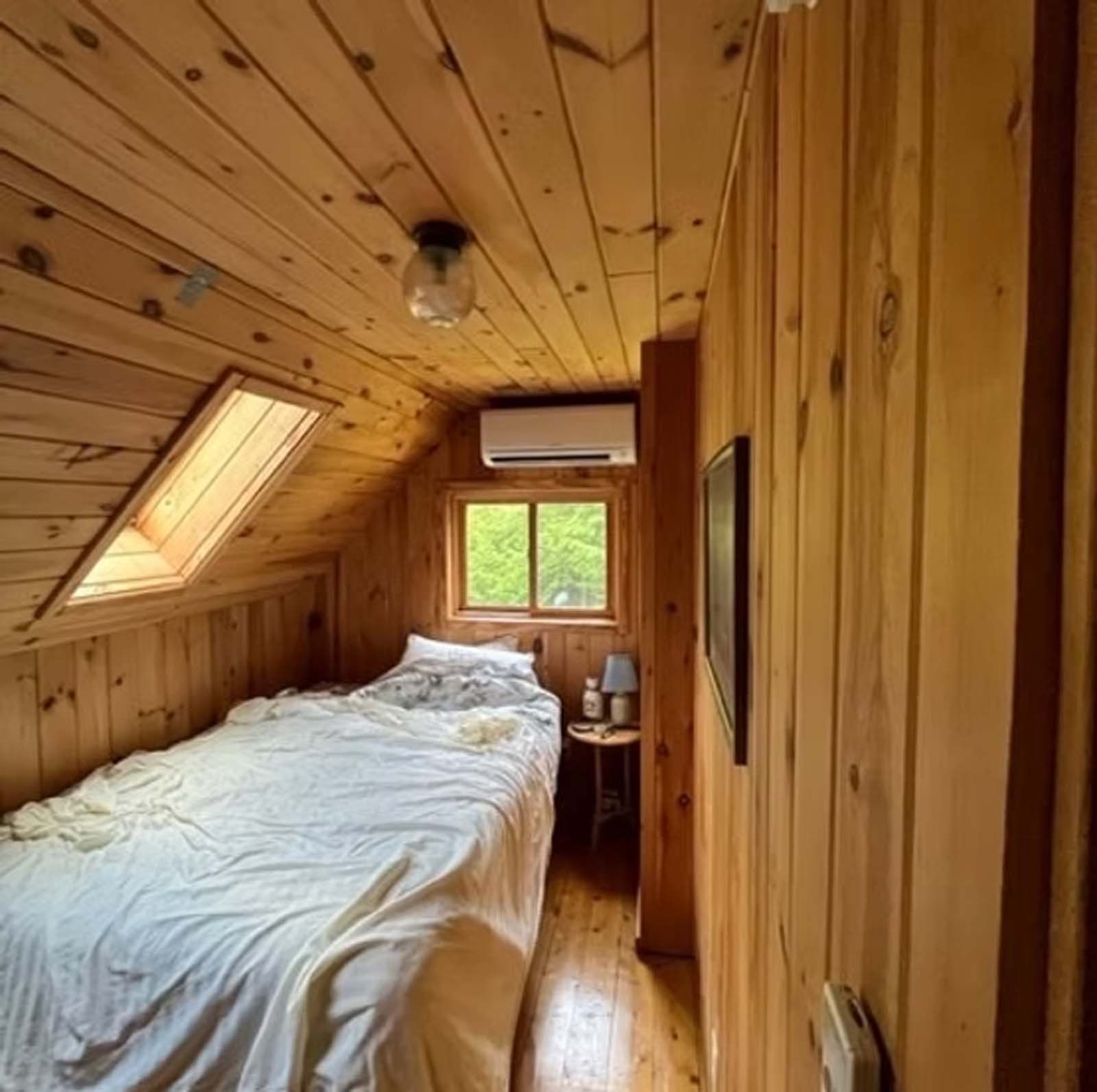 A small bedroom with a bed and a window