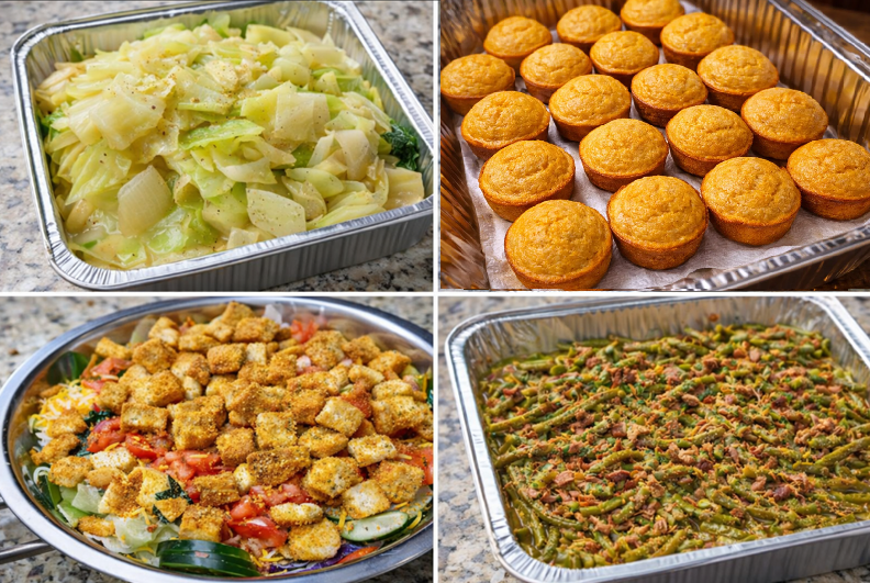 Four foil trays of catered food: salad, casserole, salmon, and green beans.