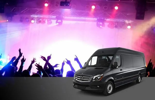 A black van is parked in front of a crowd of people
