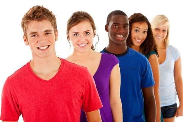 Five smiling people in bright shirts standing in a row on a white background