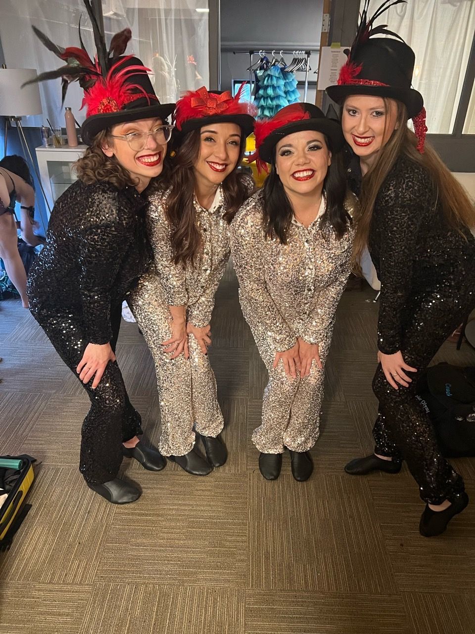 A group of women are posing for a picture while wearing top hats.