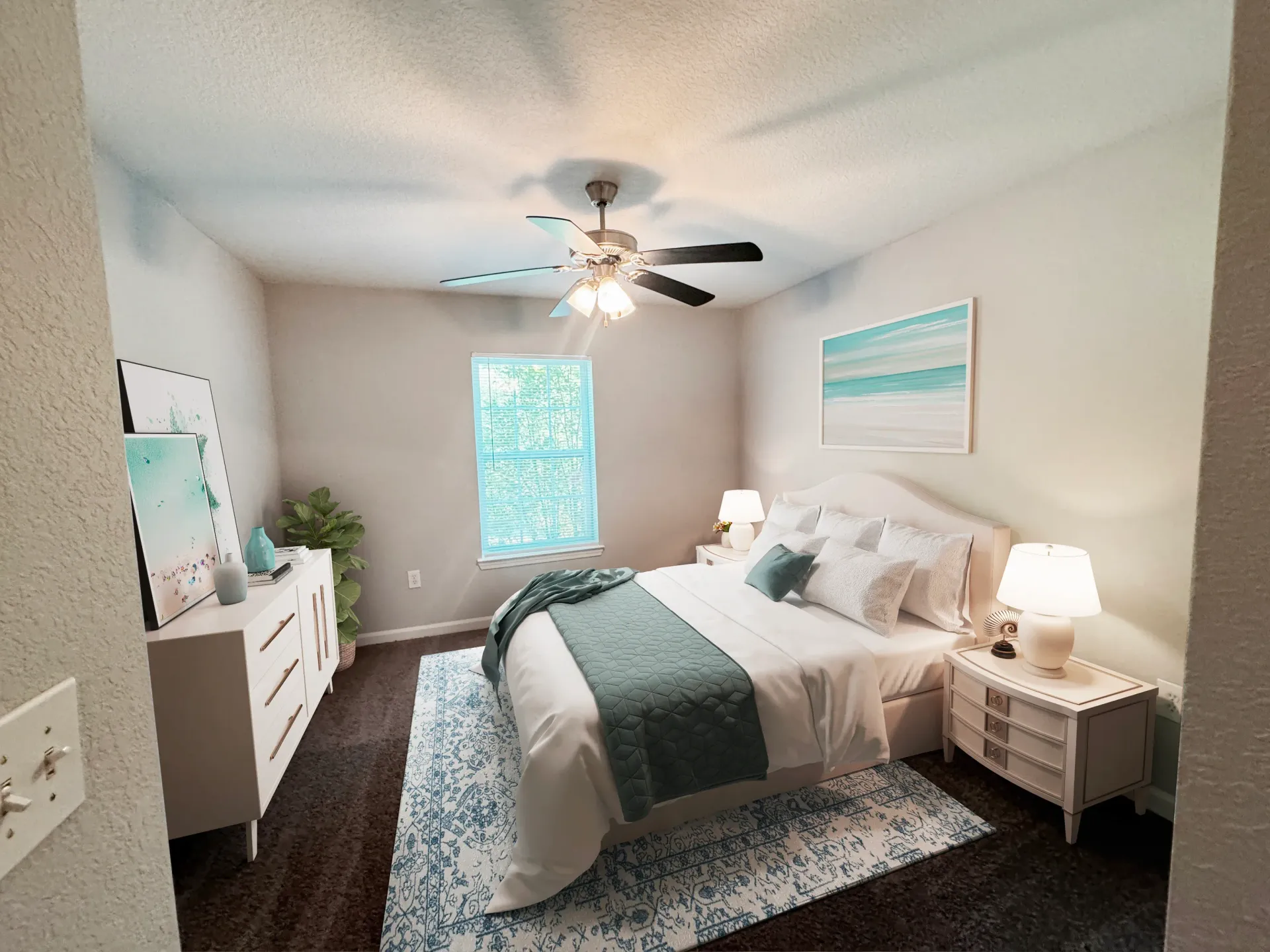 Fully furnished bedroom with a king-size bed, dresser, nightstands, and ceiling fan.