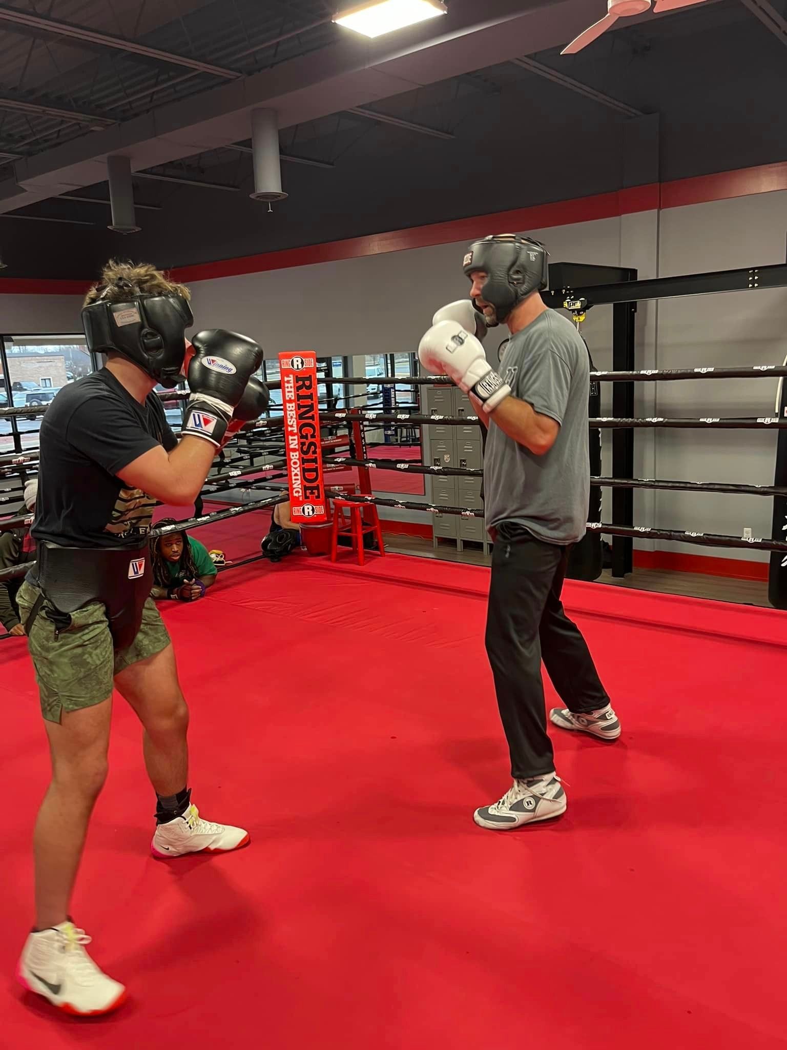 Two men boxing in the ring at Champion Boxing & Fight Club