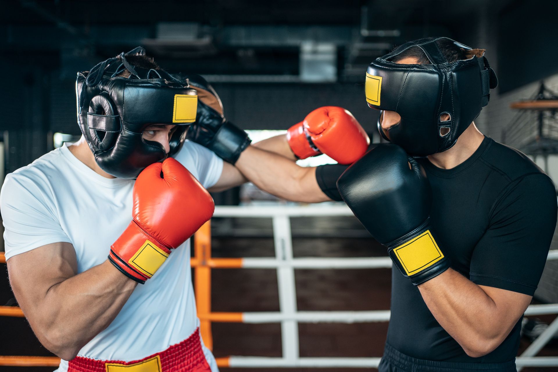 Two men in boxing gear sparring