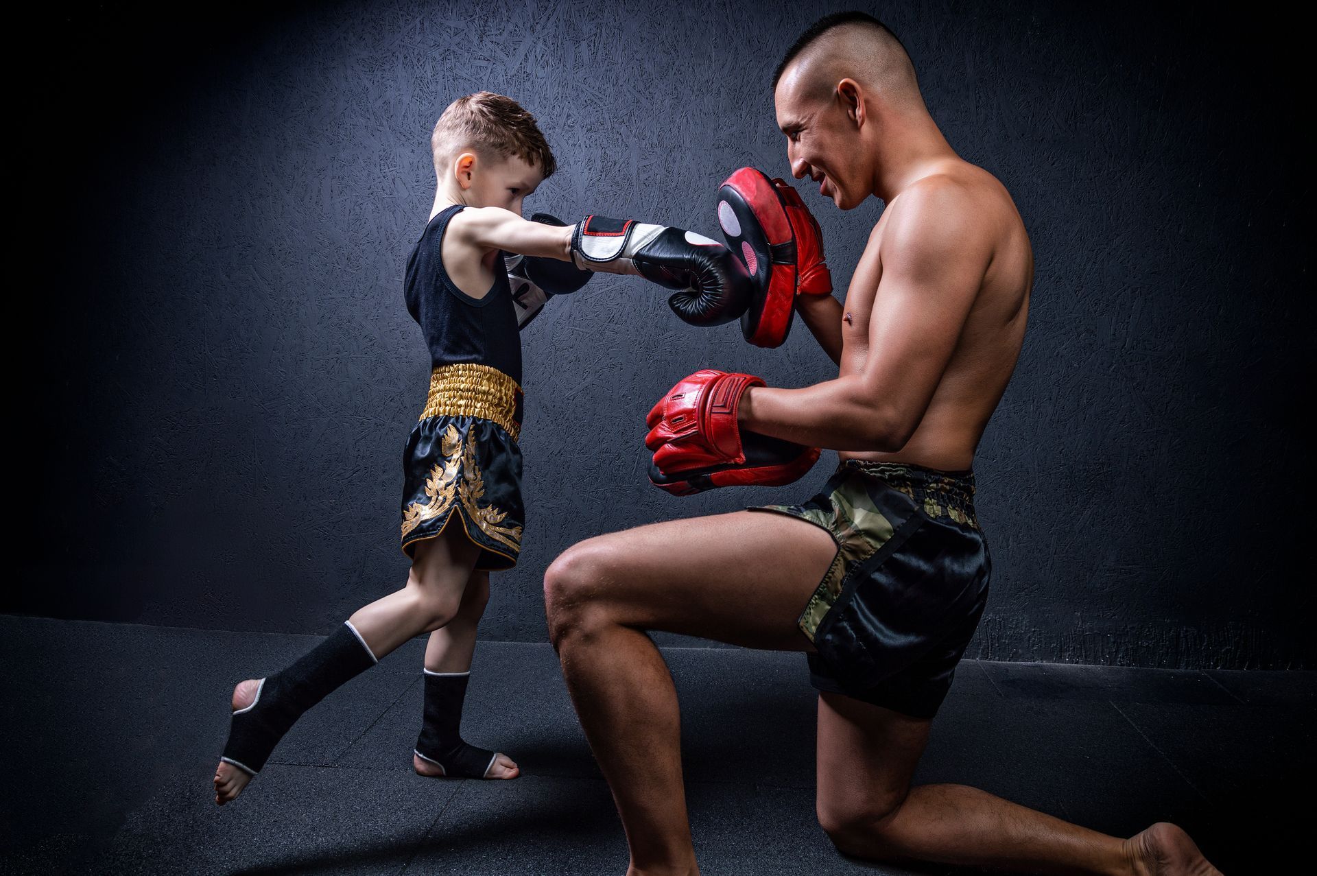 Child and man practicing boxing