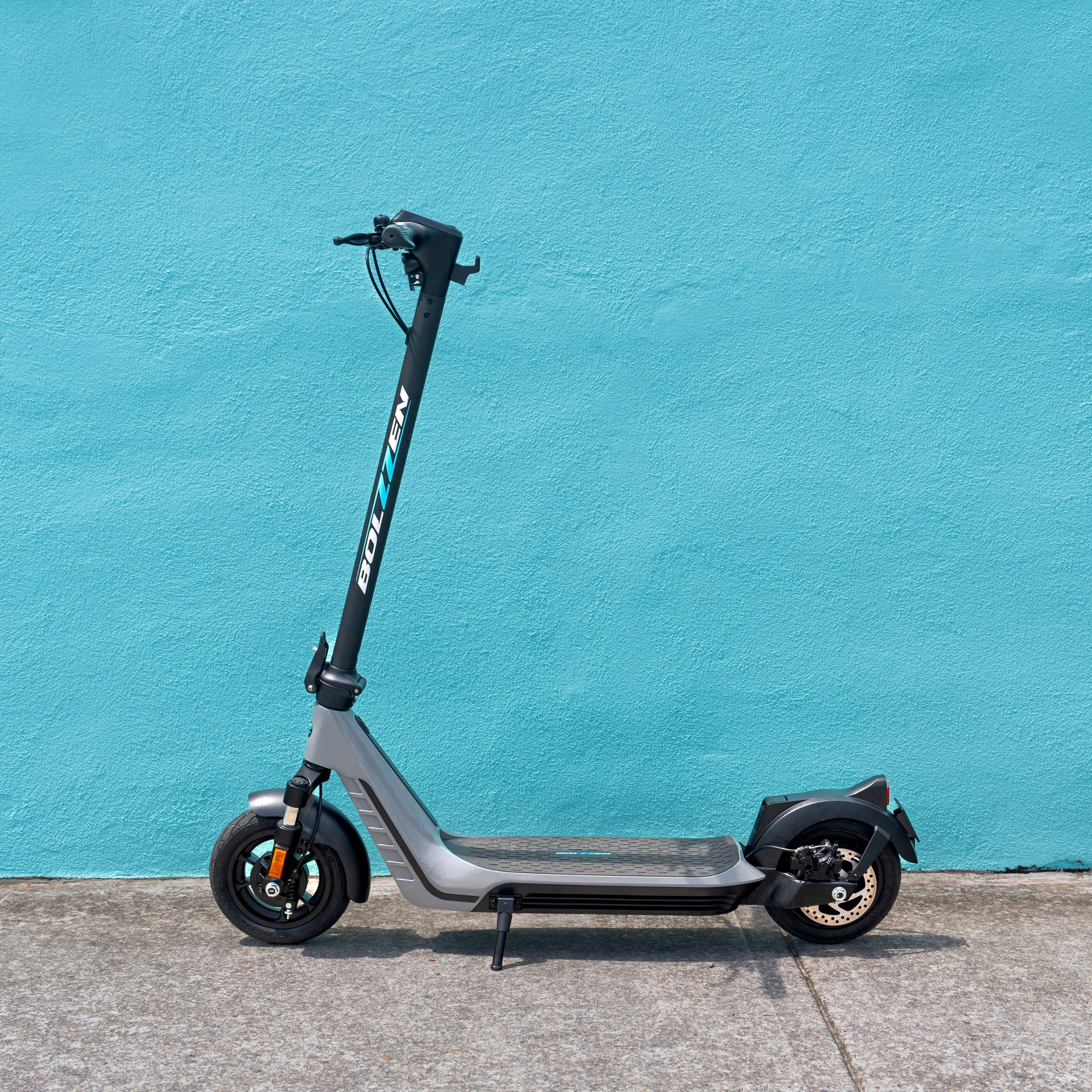 An electric Scooter is sitting in front of a blue wall. Freedom Sports - Bundaberg