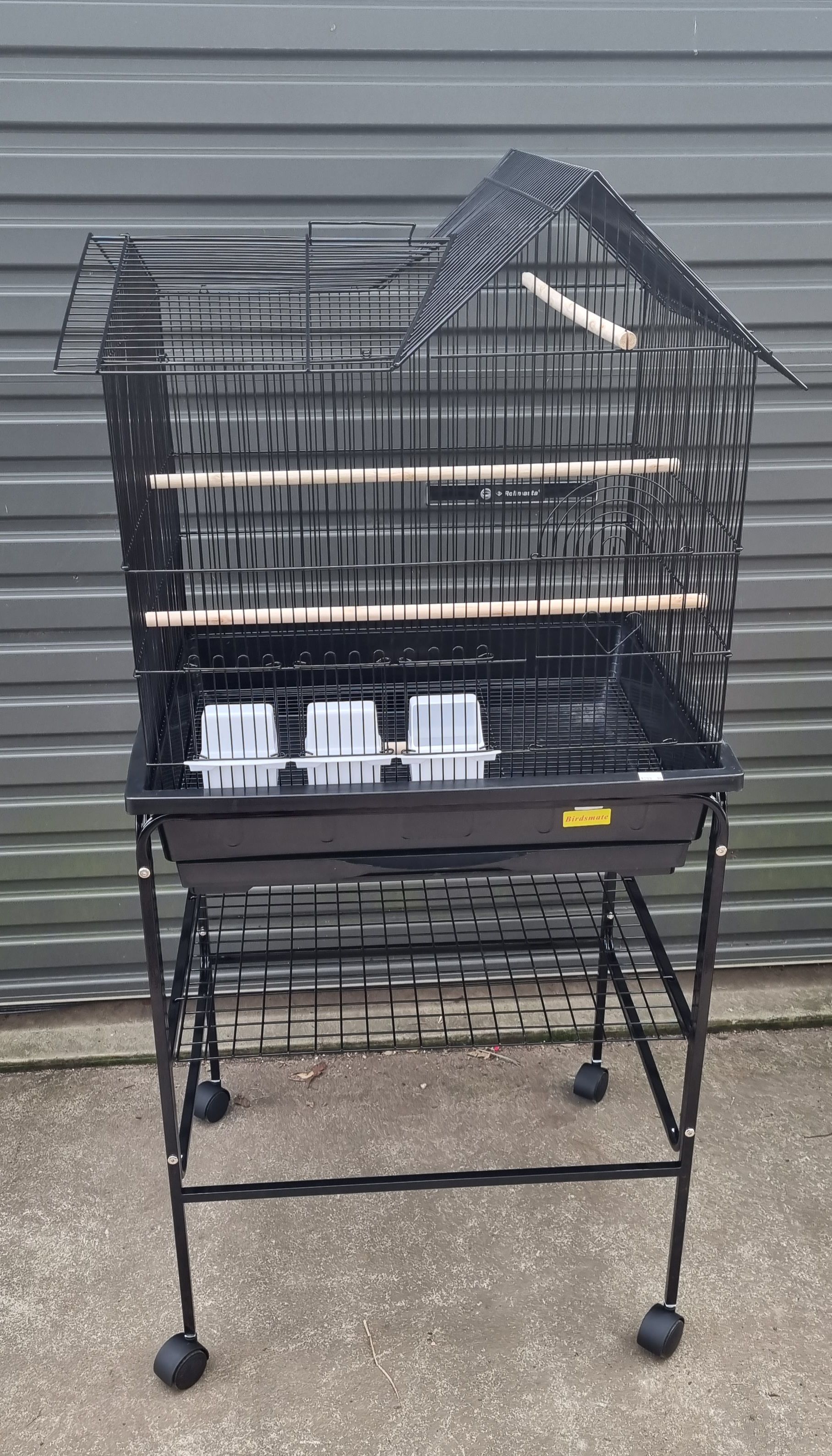 A black bird cage is sitting on top of a metal stand - Kempsey, NSW - Valley Garden Centre
