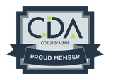 Coeur d’Alene CDA logo badge with “Proud Member” ribbon in gray, navy, and green