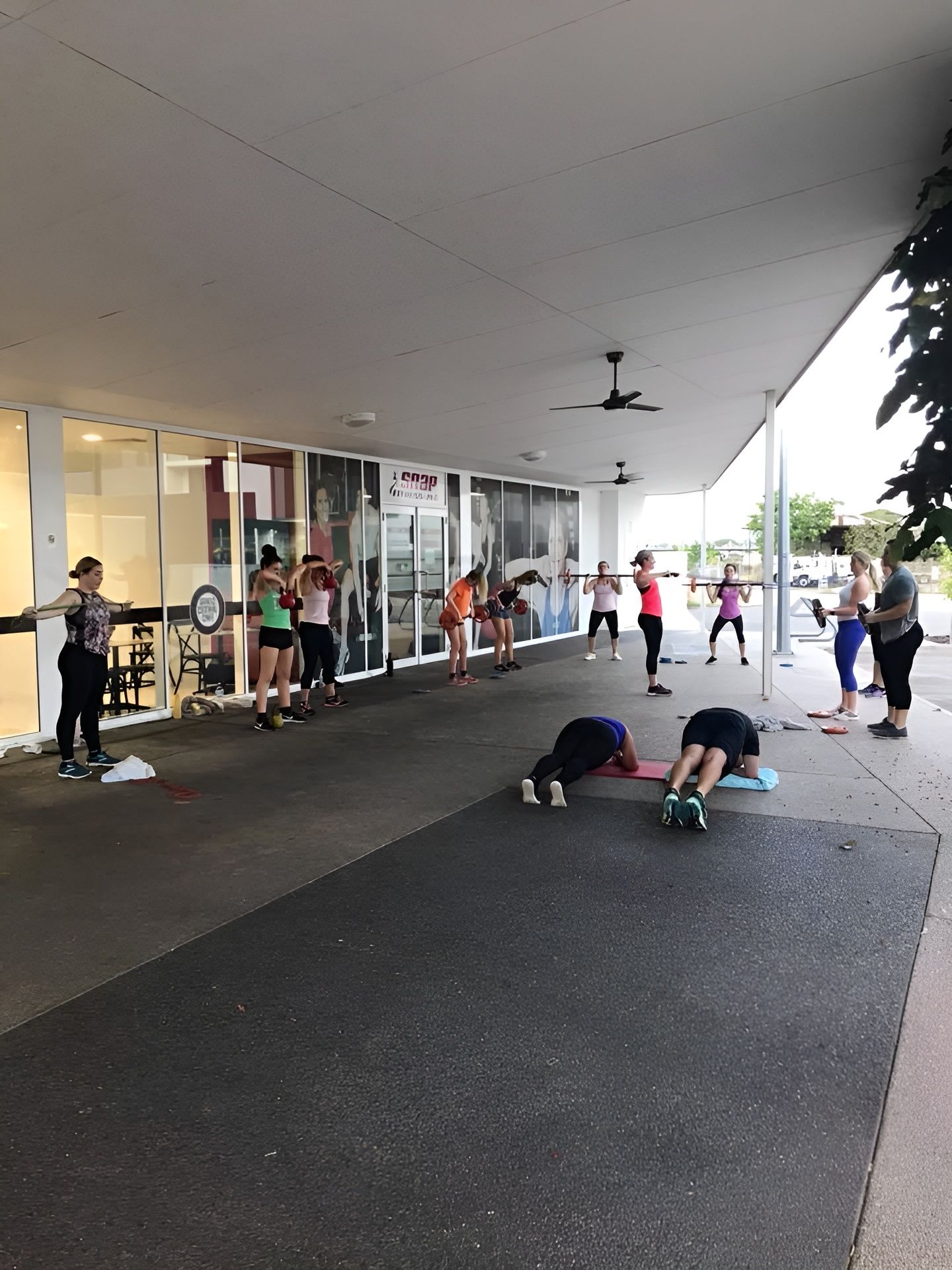 A Group of People Are Doing Exercises Outside of a Building β Health First Townsville In Townsville, QLD