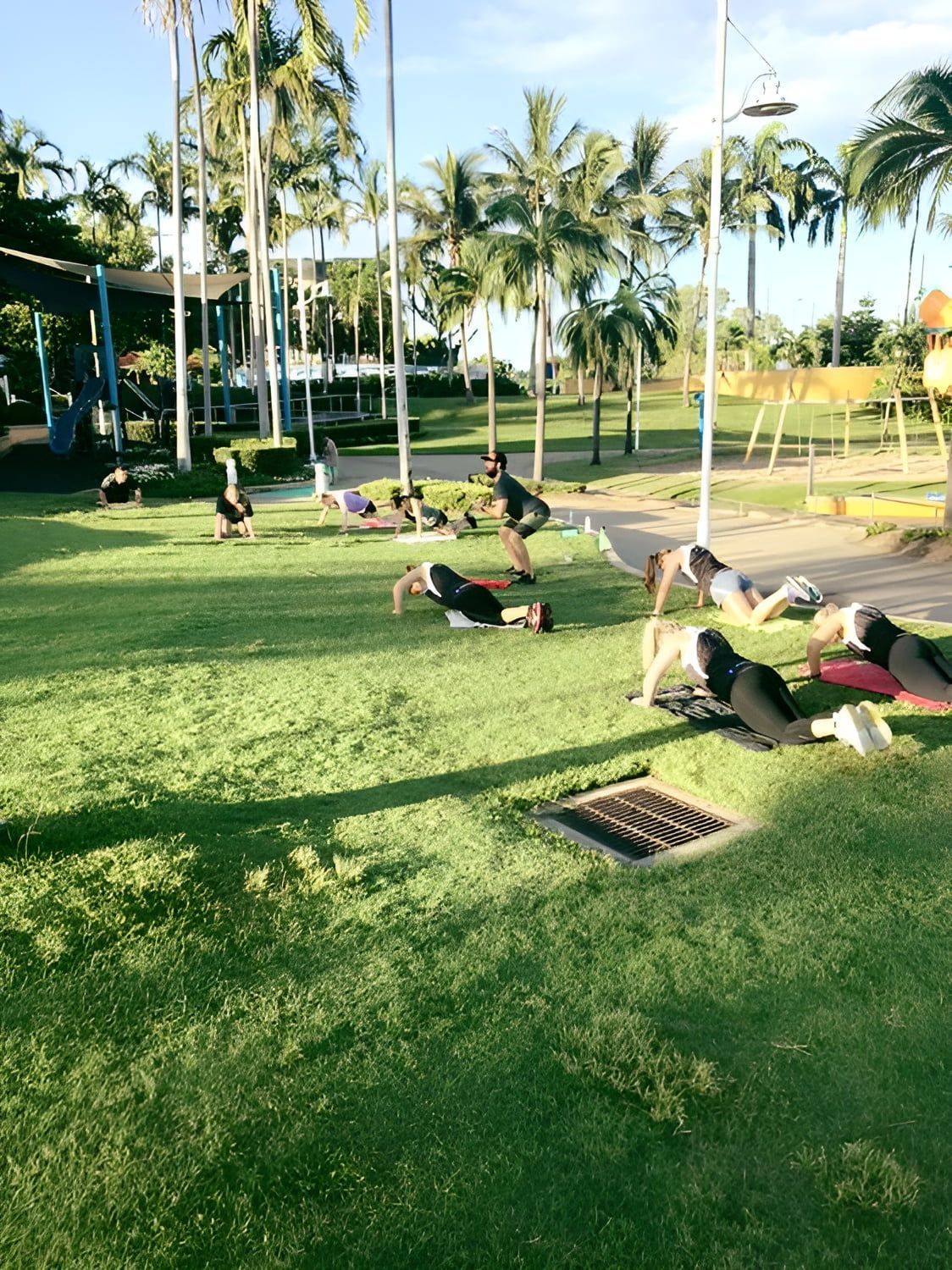 A Group of People Are Doing Push Ups on the Grass in a Park β Health First Townsville In Townsville, QLD