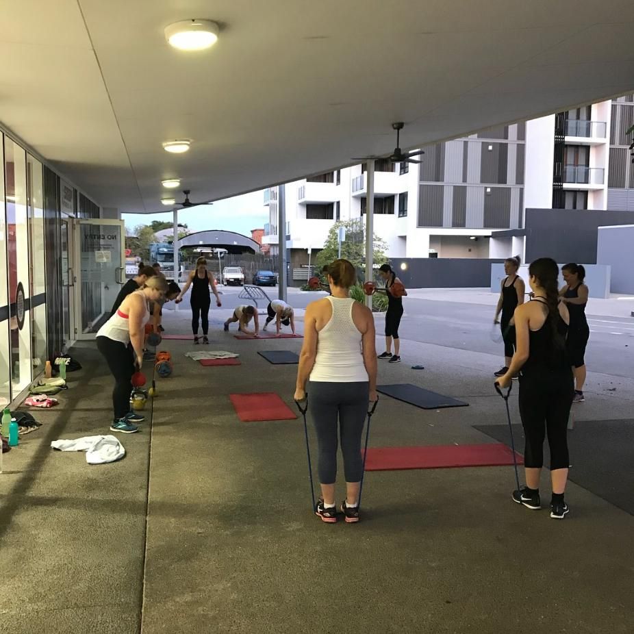 A Group of People Are Doing Exercises on a Sidewalk β Health First Townsville In Townsville, QLD