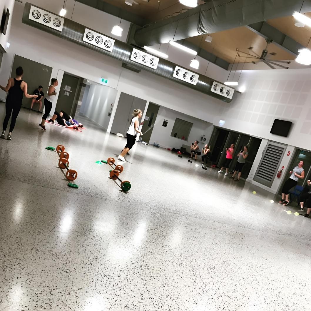 A Group of People Are Doing Exercises in a Gym β Health First Townsville In Townsville, QLD