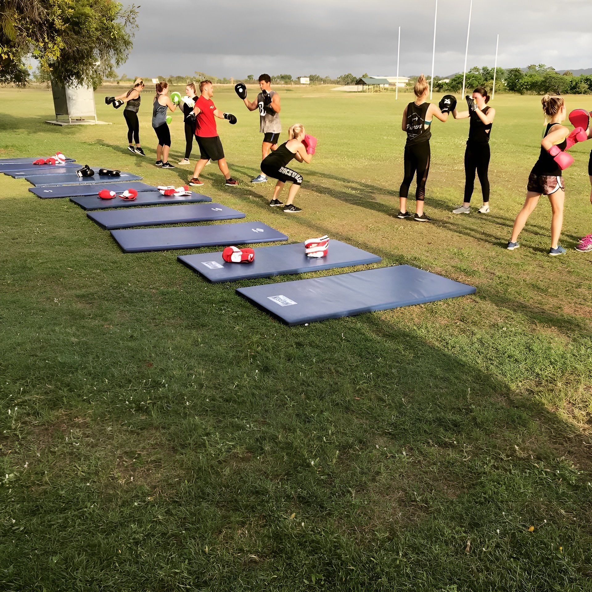 A Group of People Are Practicing Boxing in a Field β Health First Townsville In Townsville, QLD