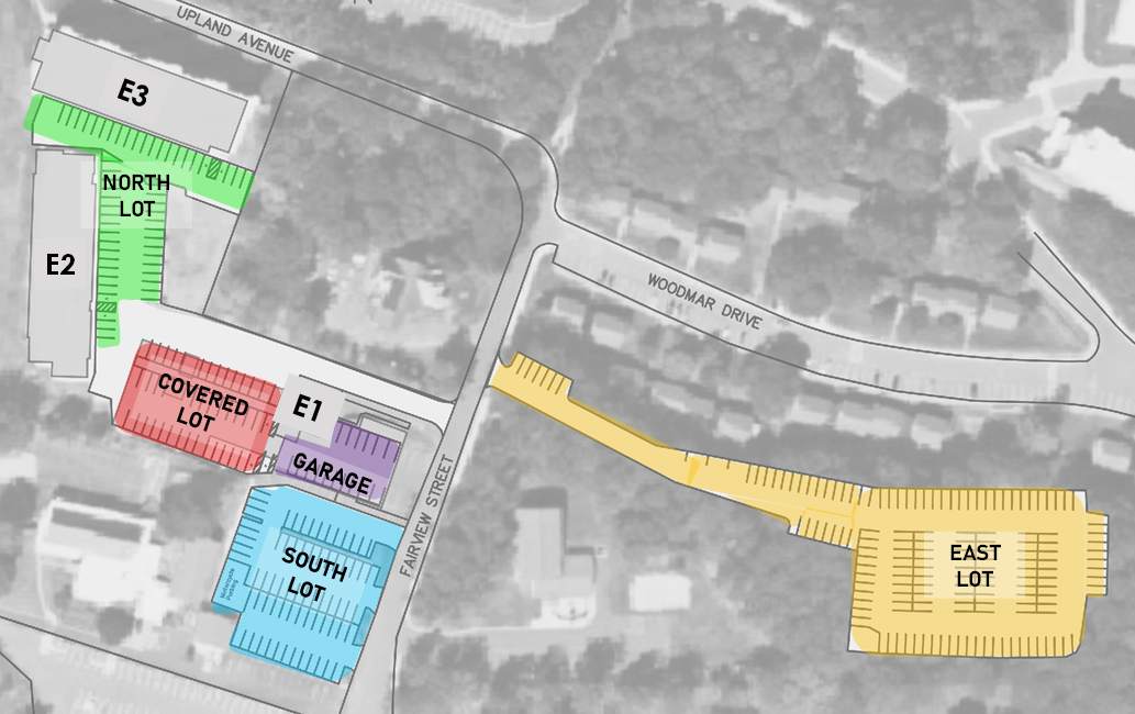 Annotated aerial site map with colored building zones and a yellow access road leading to a labeled facility