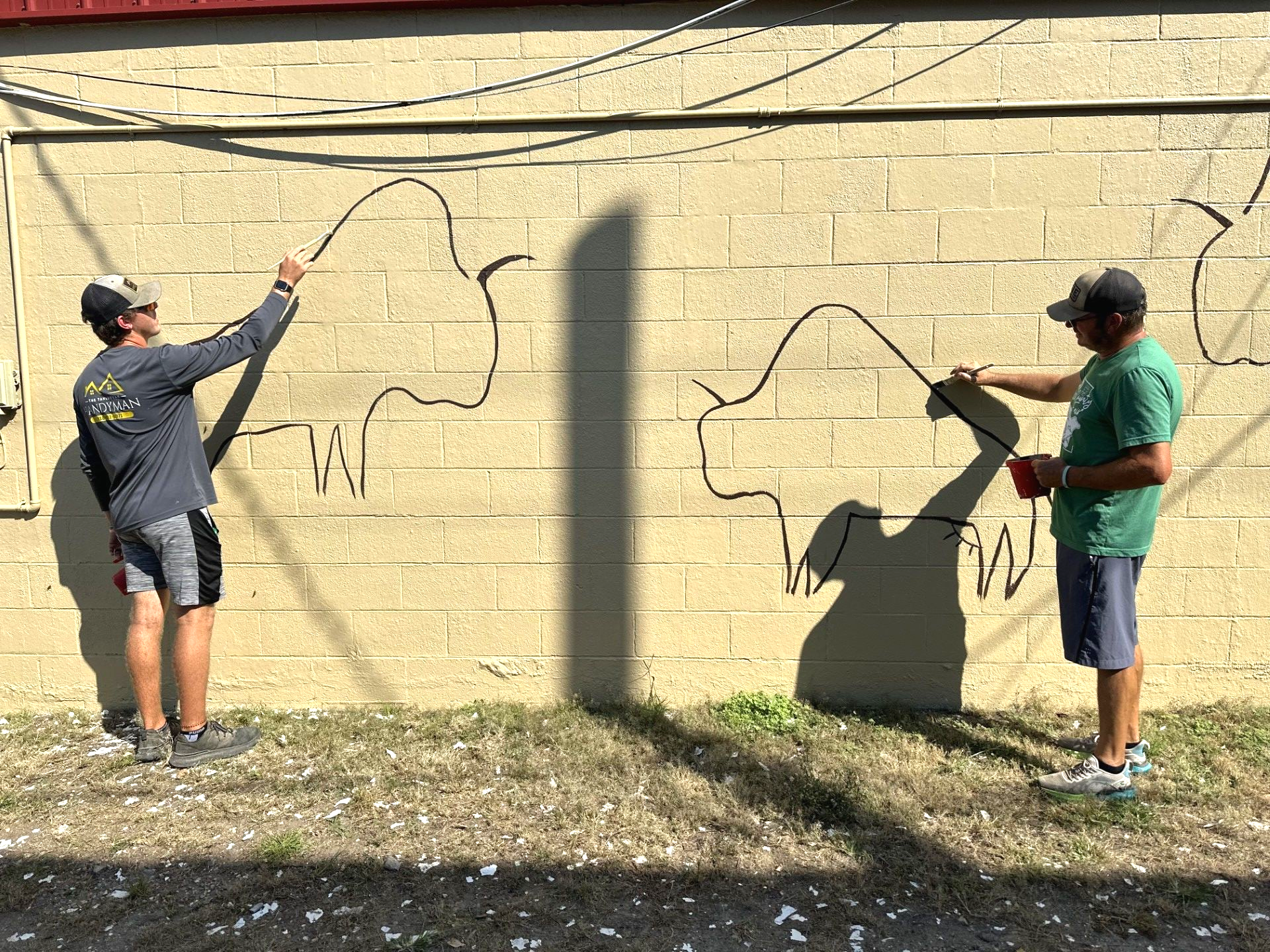Sean and Kegan Bradford work on a mural in Stilwell Oklahoma